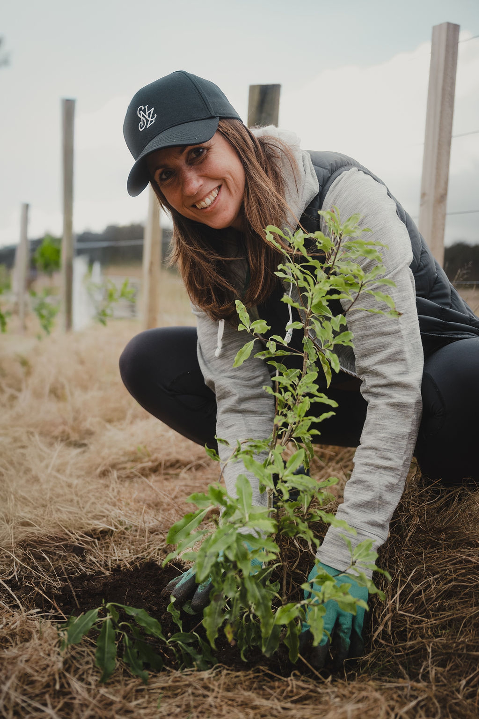 A volunteer plants a native tree