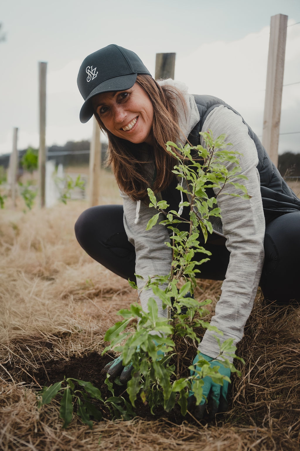 A volunteer plants a native tree