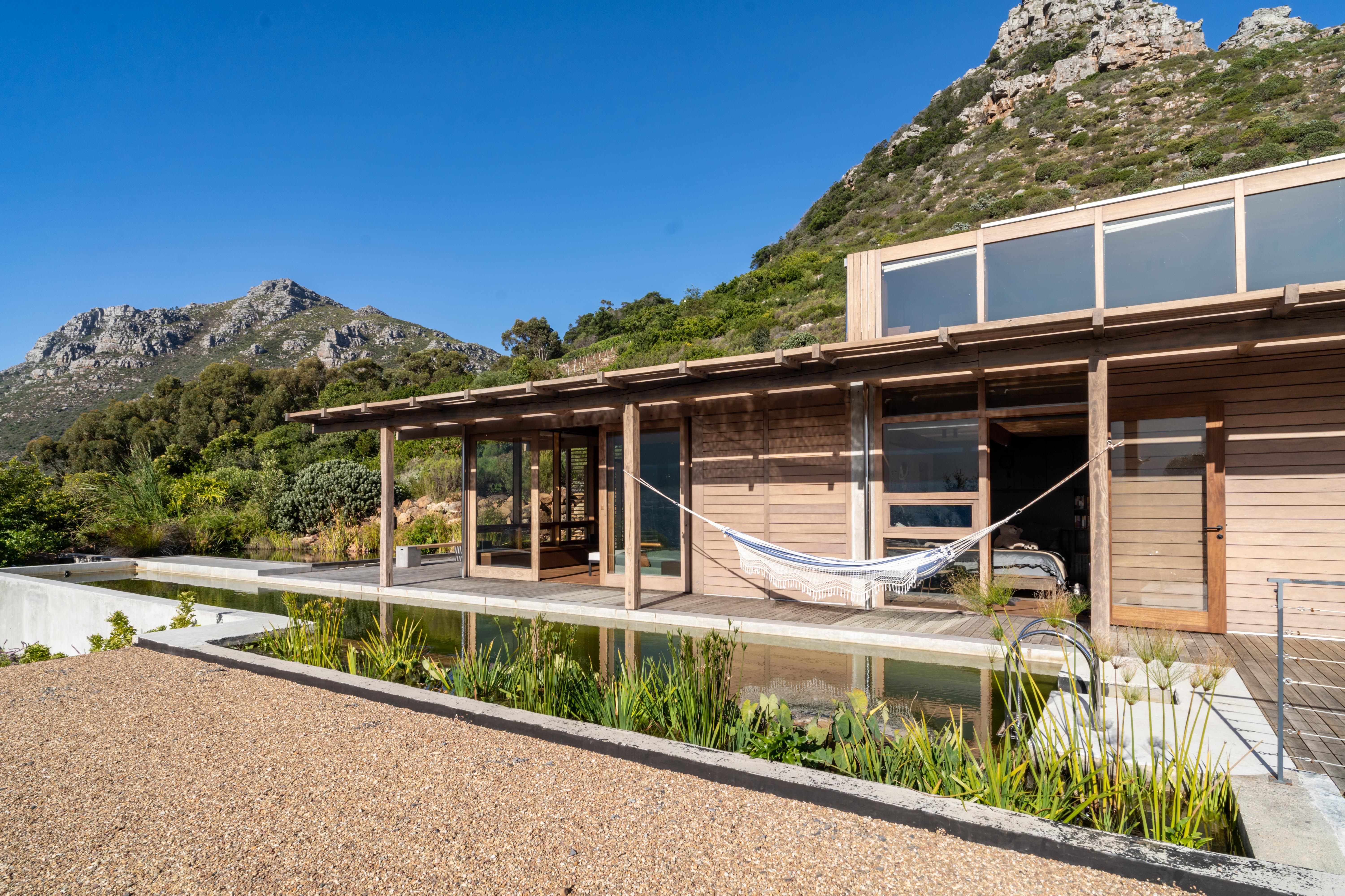 Full house elevation with mountain ridge and pool below