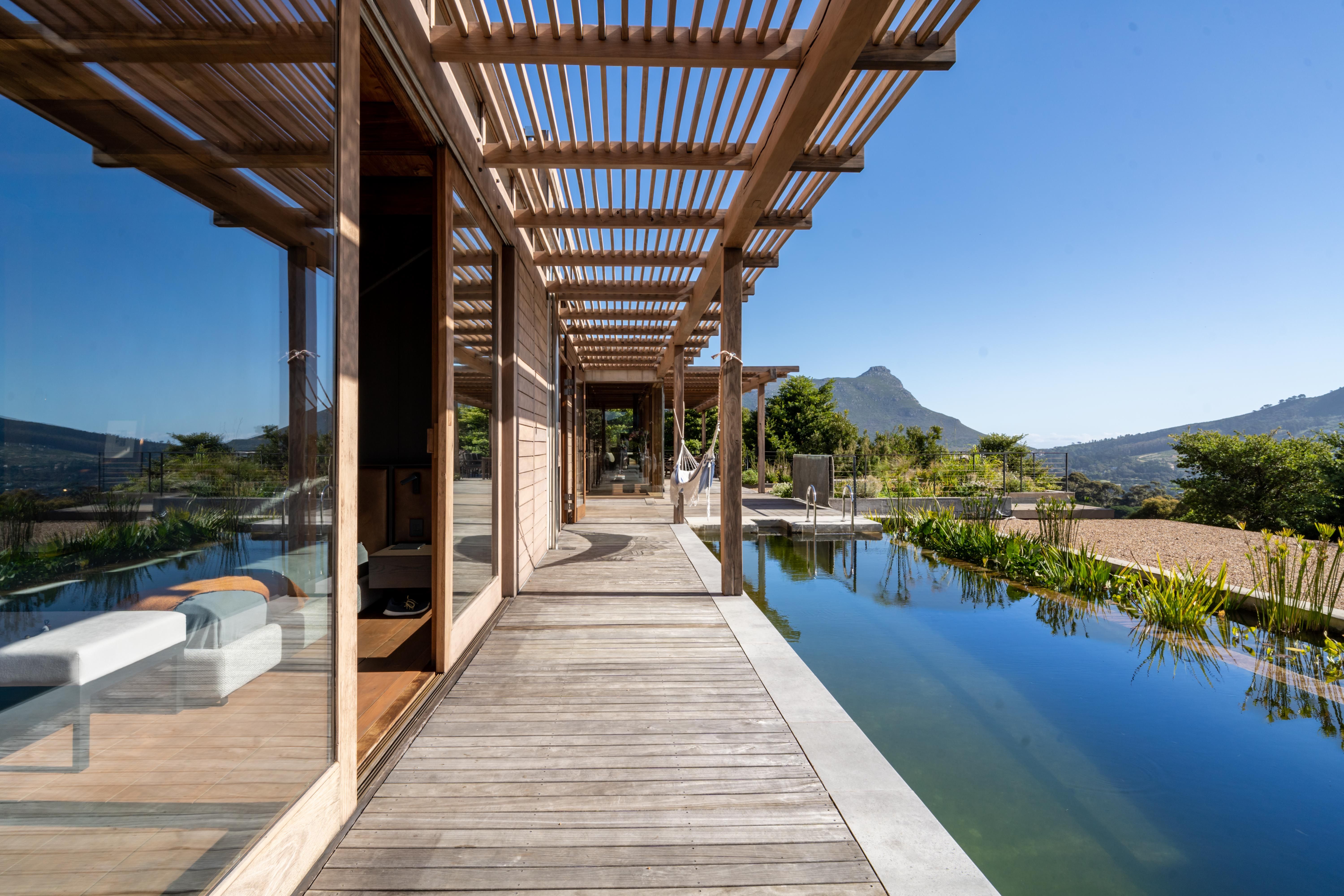 Iroko pergola walkway alongside the 20-metre lap pool