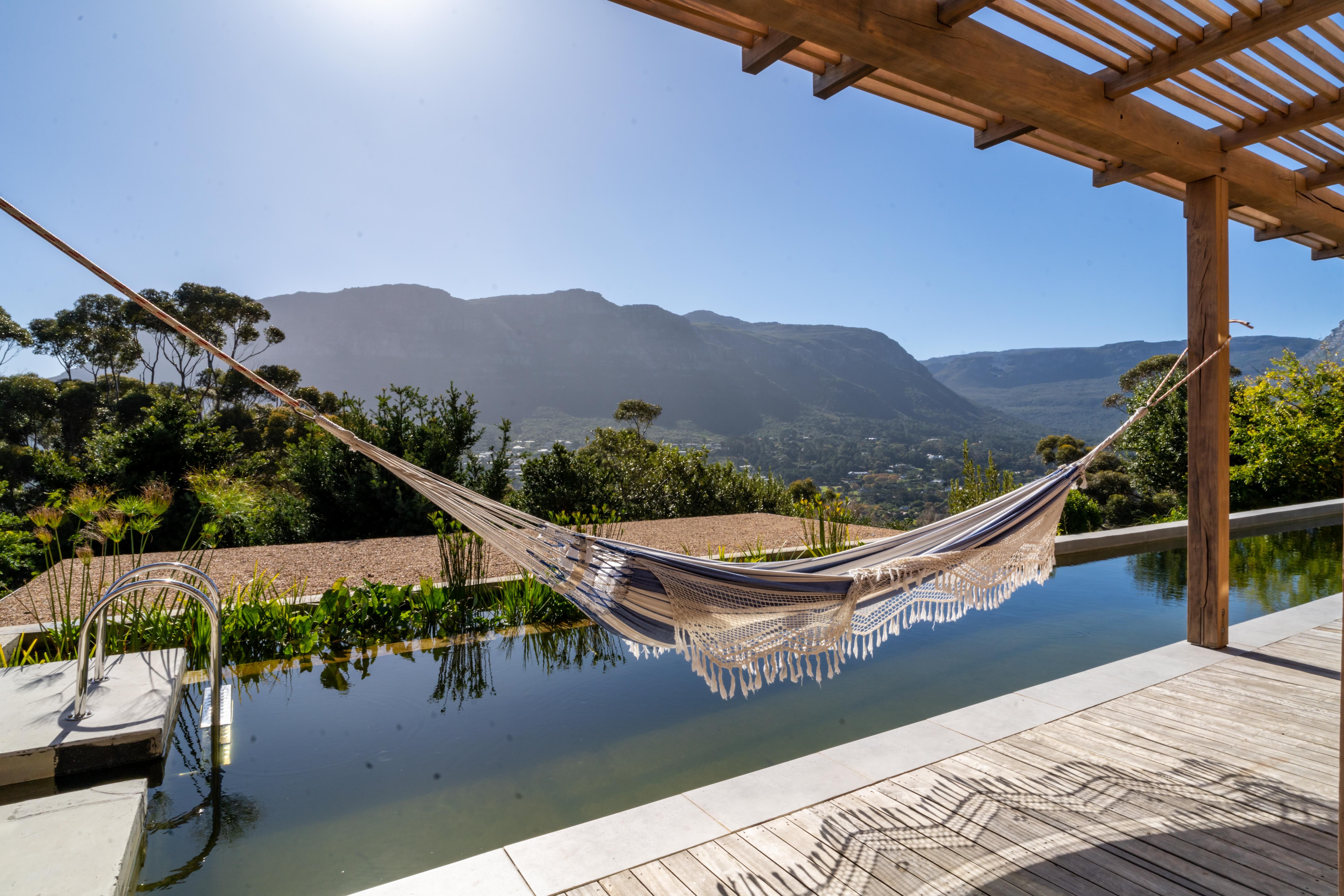 Hammock above the lap pool, looking across the valley to the mountain ridge with the Table Mountain cable-car peak on the right