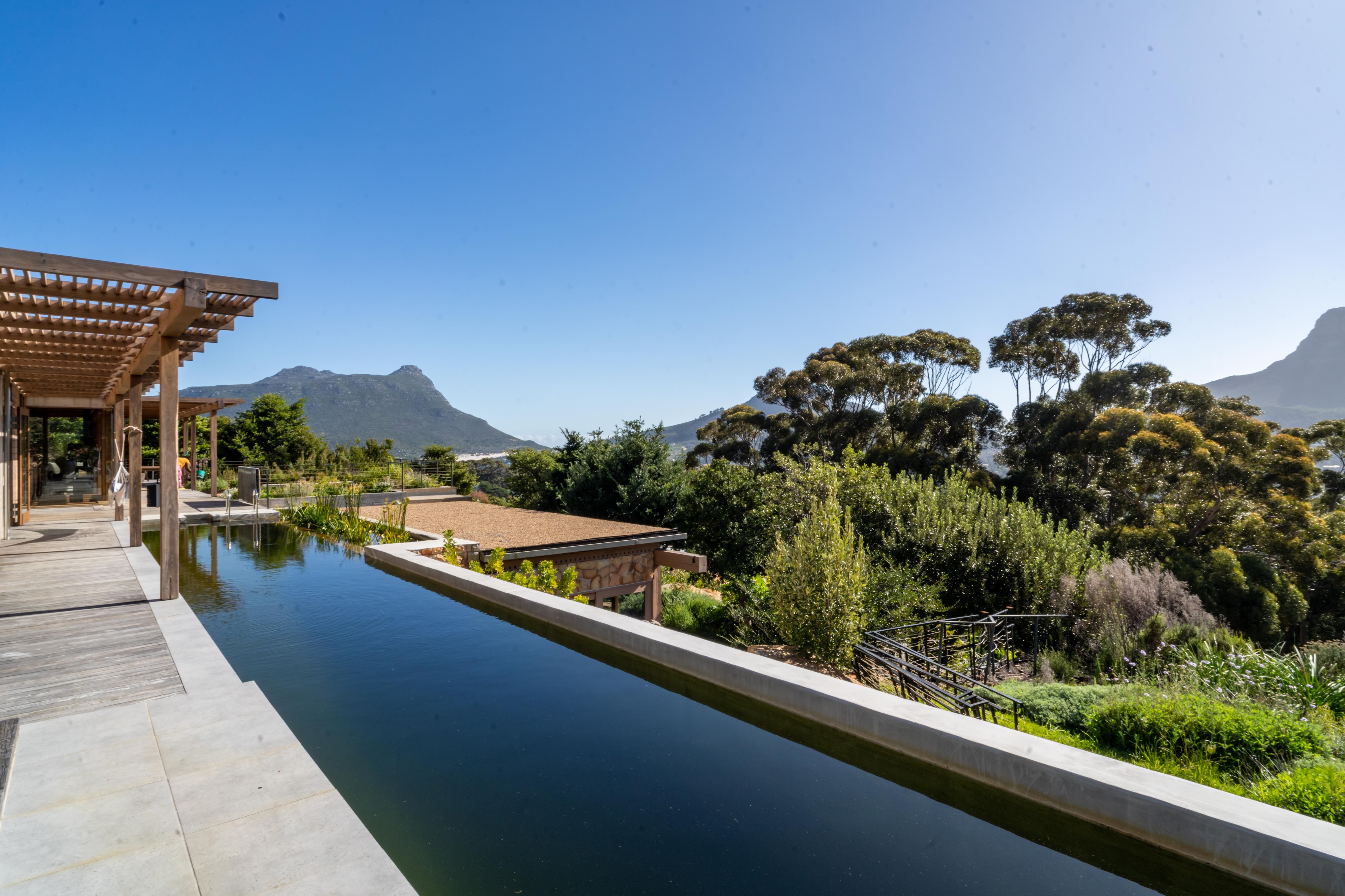 Pool infinity edge with mountain panorama beyond