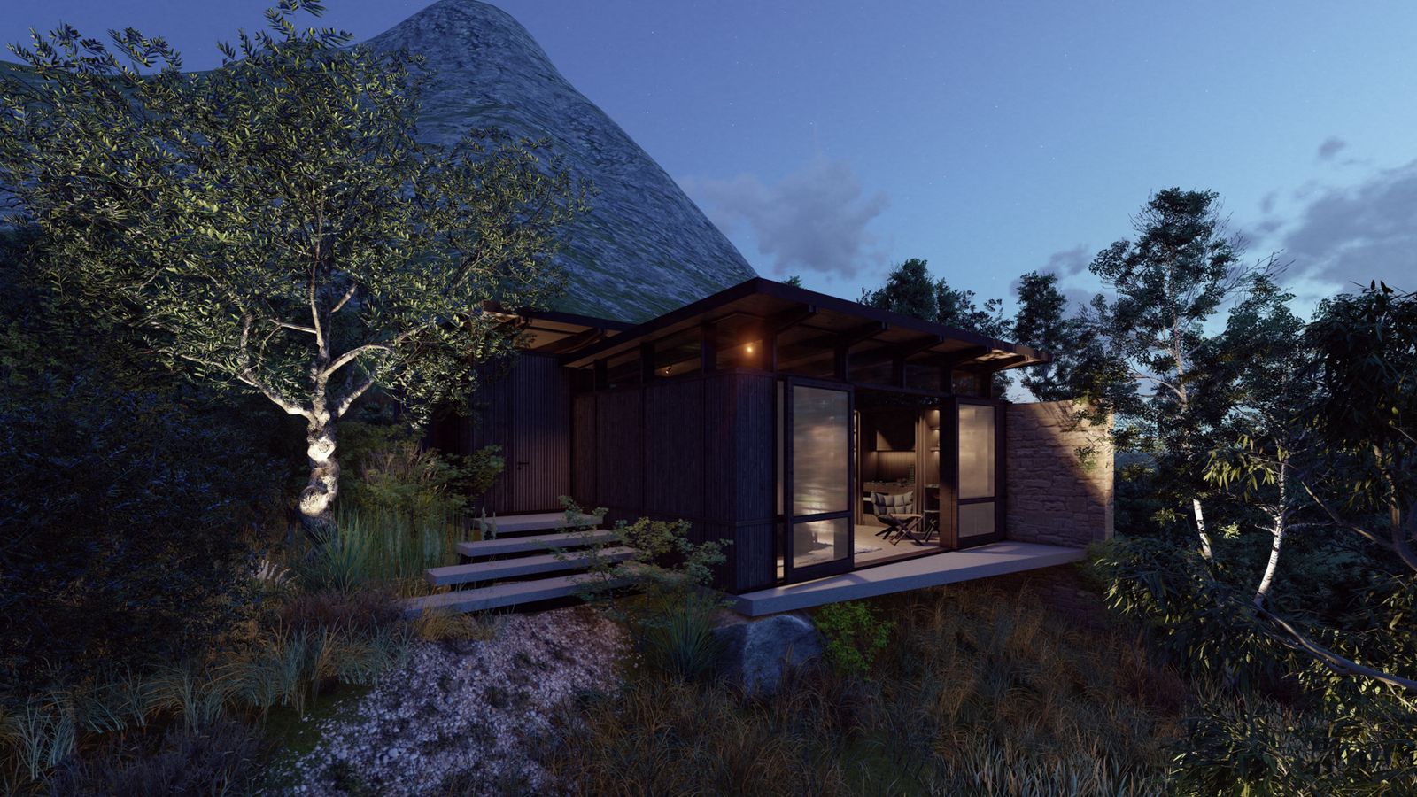 Writers Cottage at night: warm interior glow through the glass facade, soft uplight on a tree, the mountain rising in the deep-blue twilight