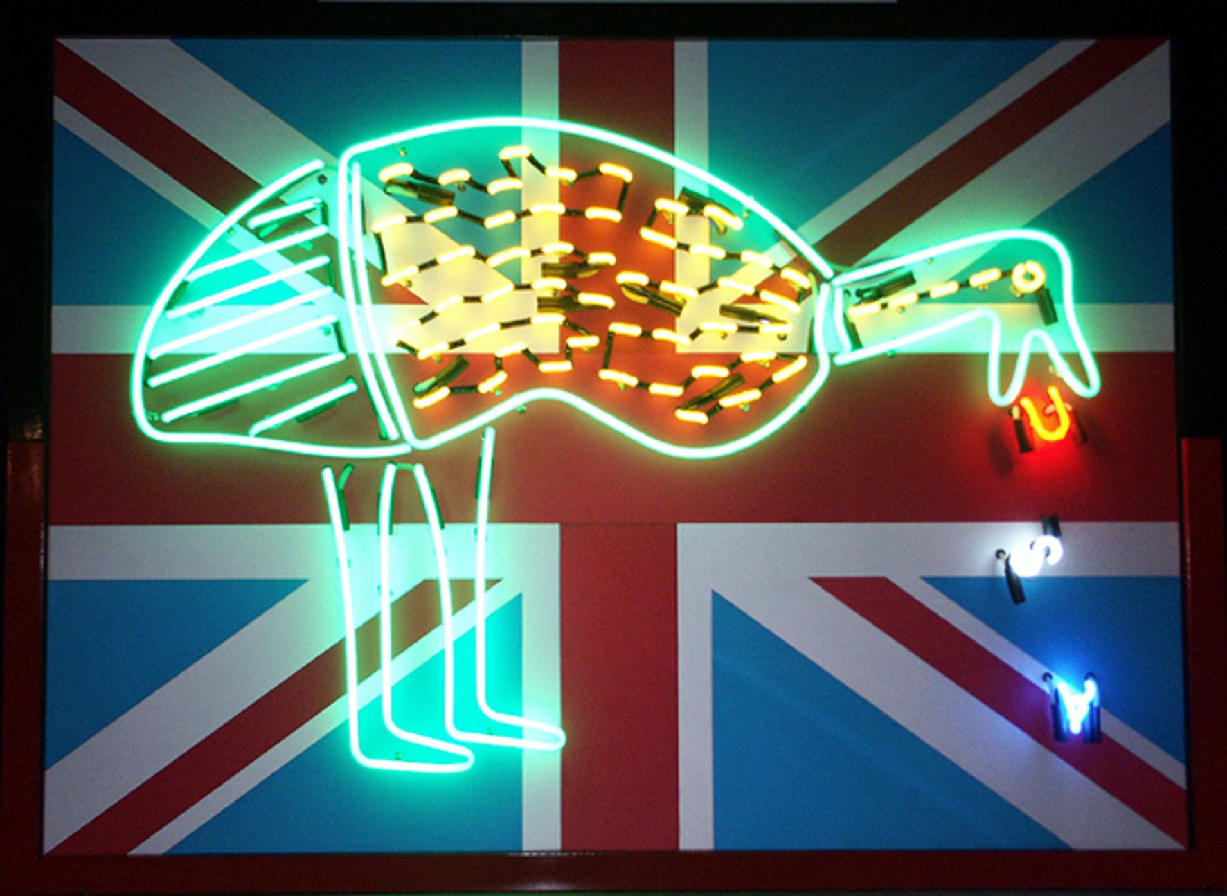 A neon sign of an emu stands in front of a British flag, with the birds beak holding red and blue neon letters “U” "S" “A.”.