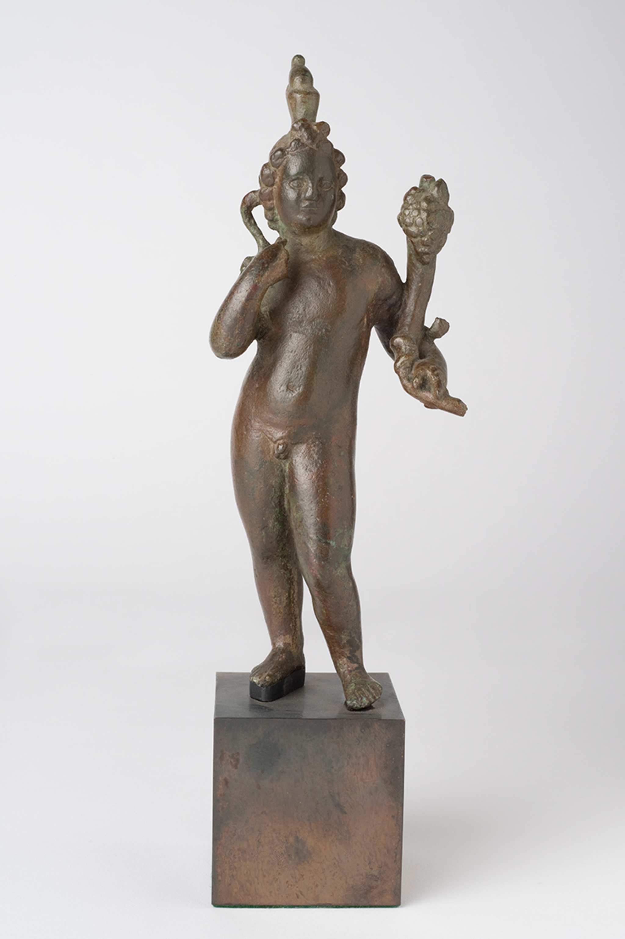 A bronze figurine of a nude figure on a small pedestal