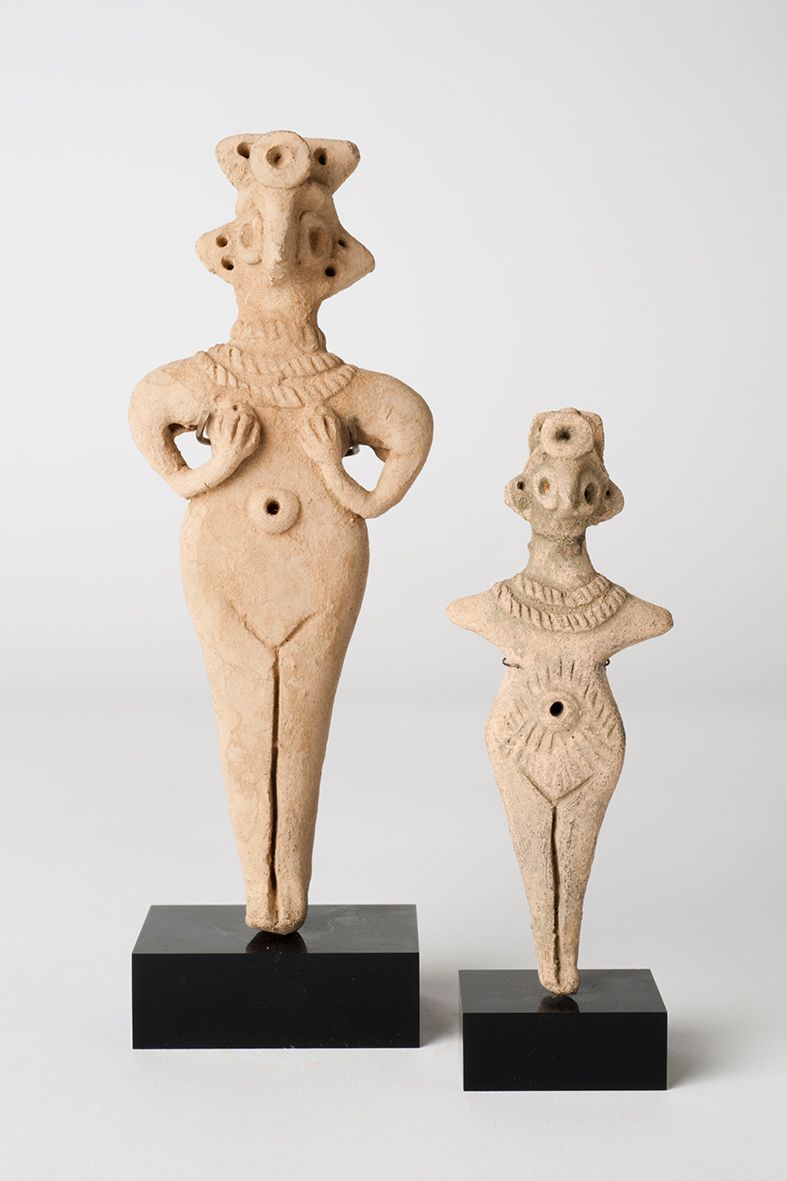 Two terracotta figurines of semi-abstracted human shapes in a row