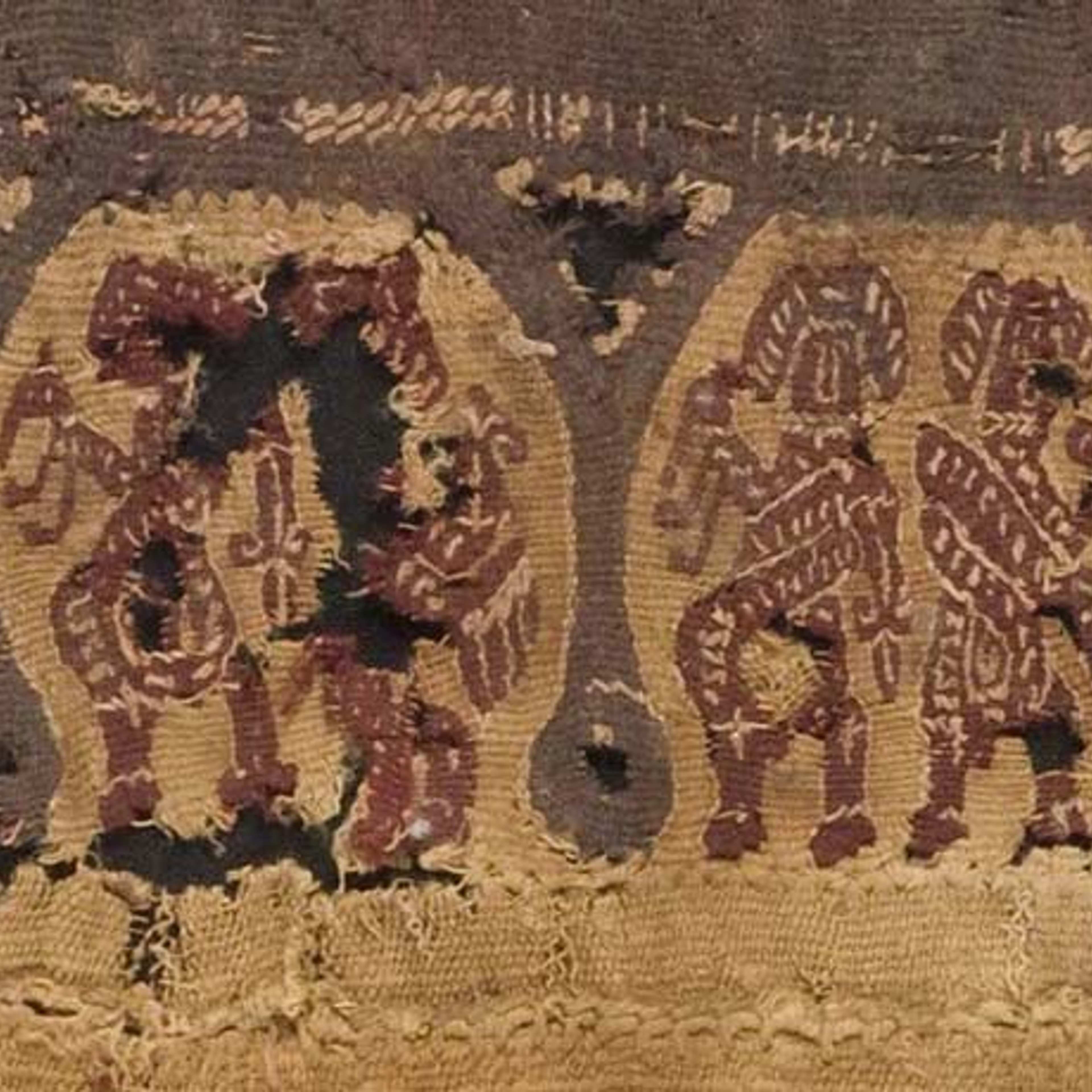 An ancient brown and red tapestry with semi-abstracted figures