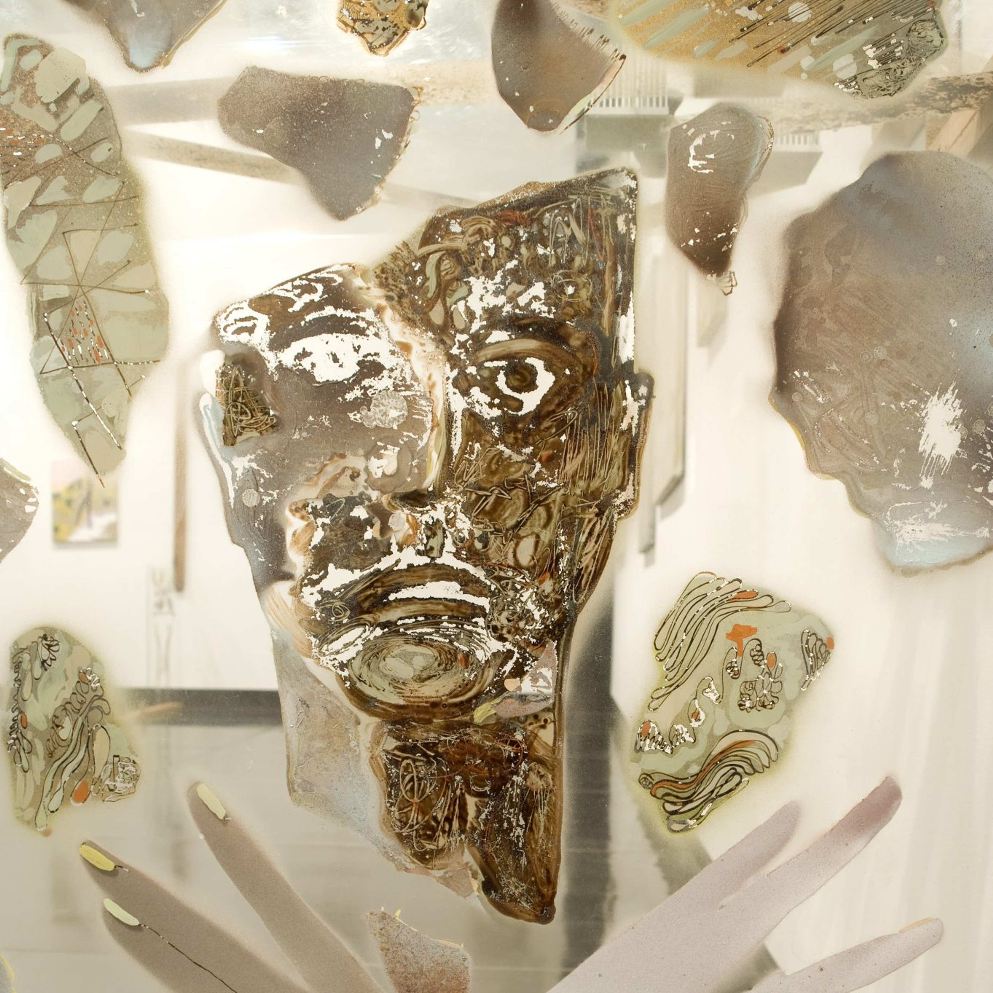 A collage with a human face and crossed hands on a transparent support