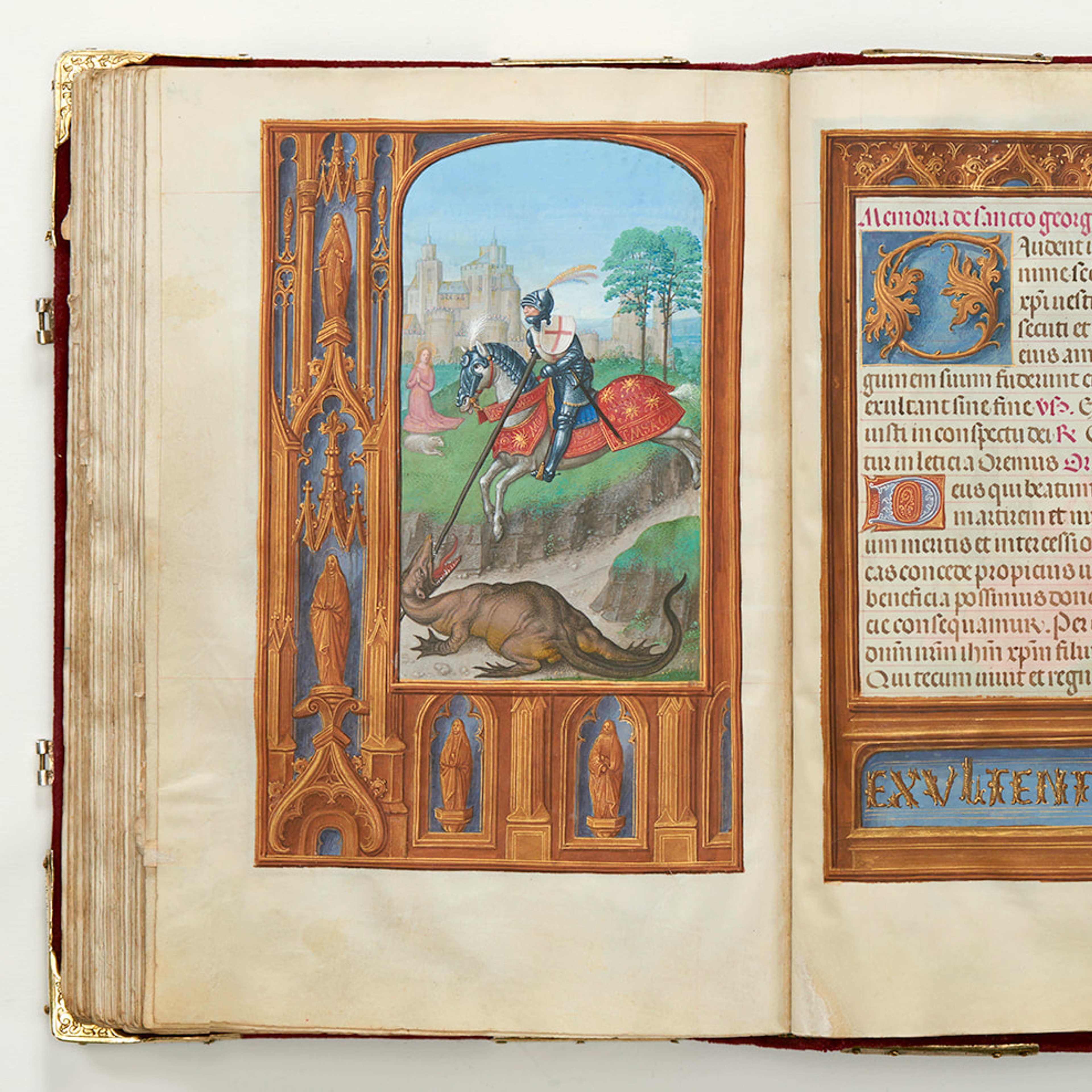 A medieval book open on the pages with illuminations
