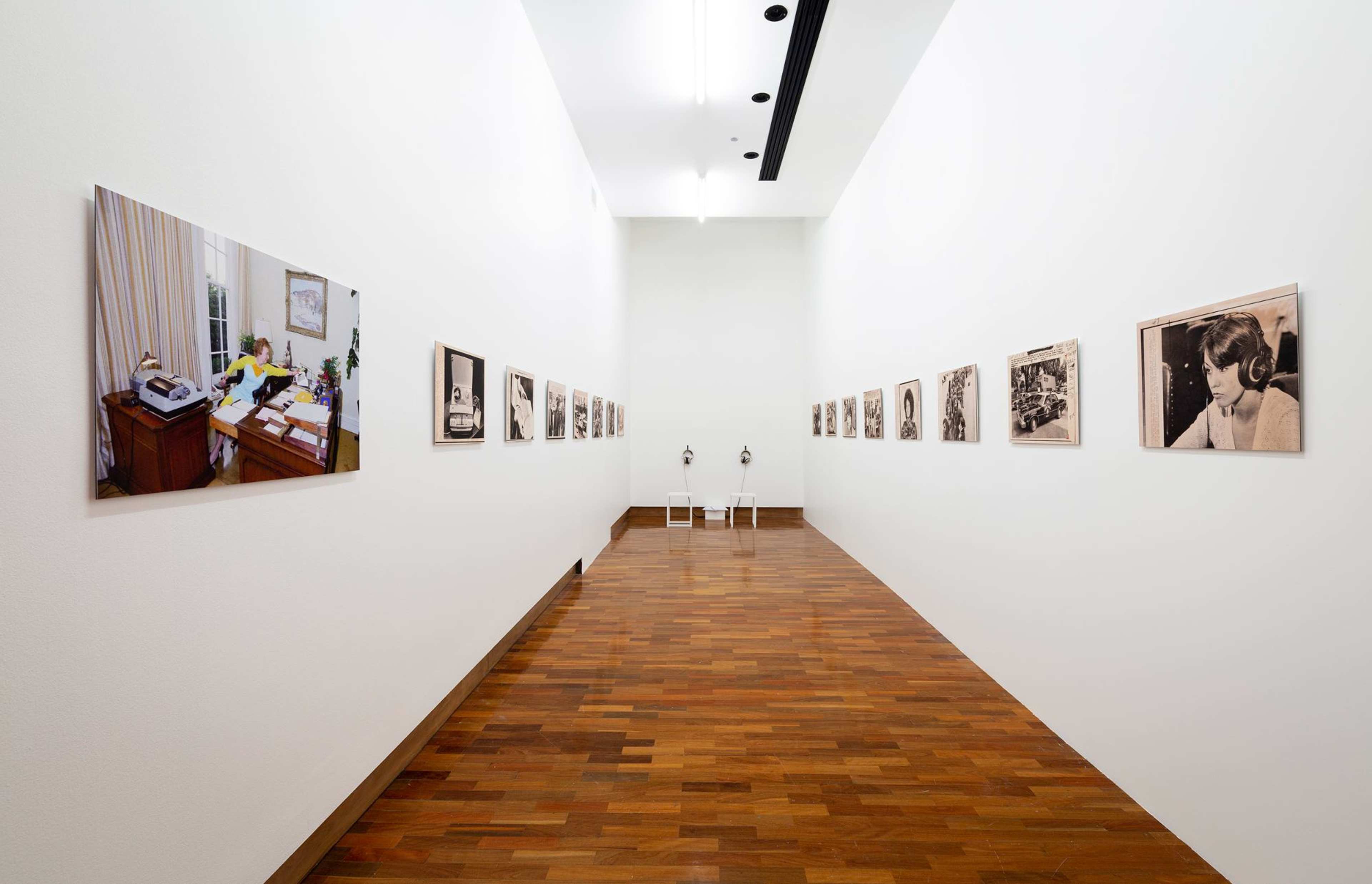 A corridor lined with photographs of different listening scenarios