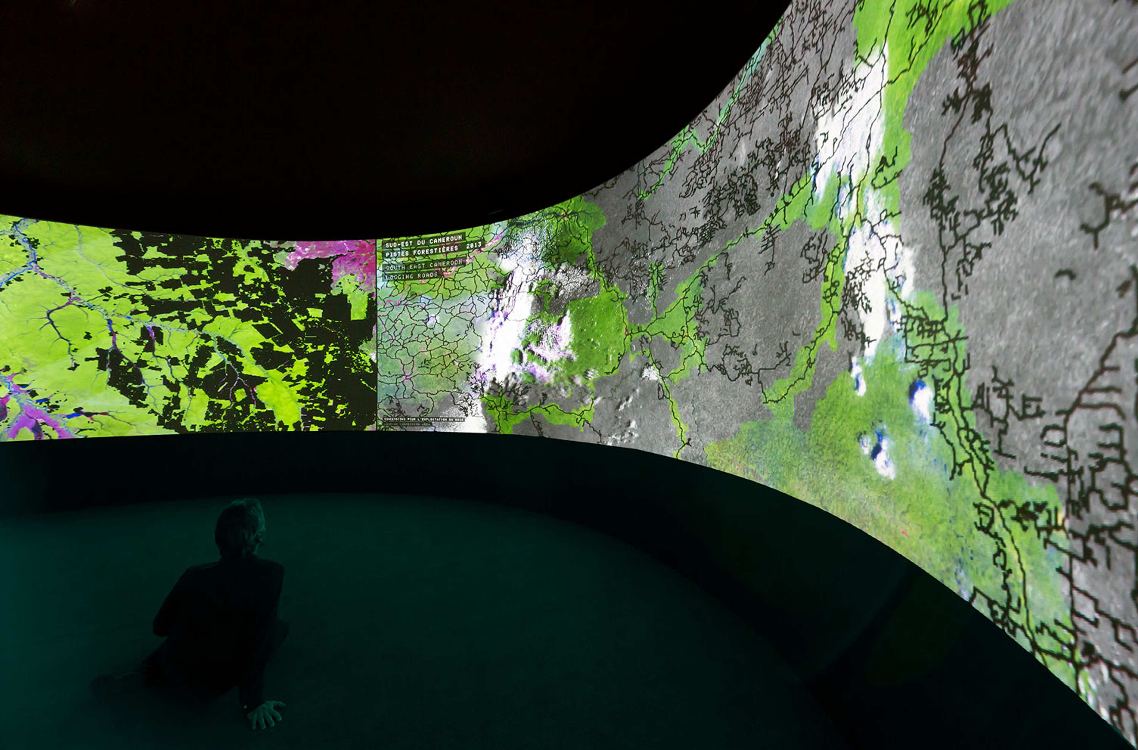 Wrap-around-the-room projection of an infographic featuring a close-up of a map