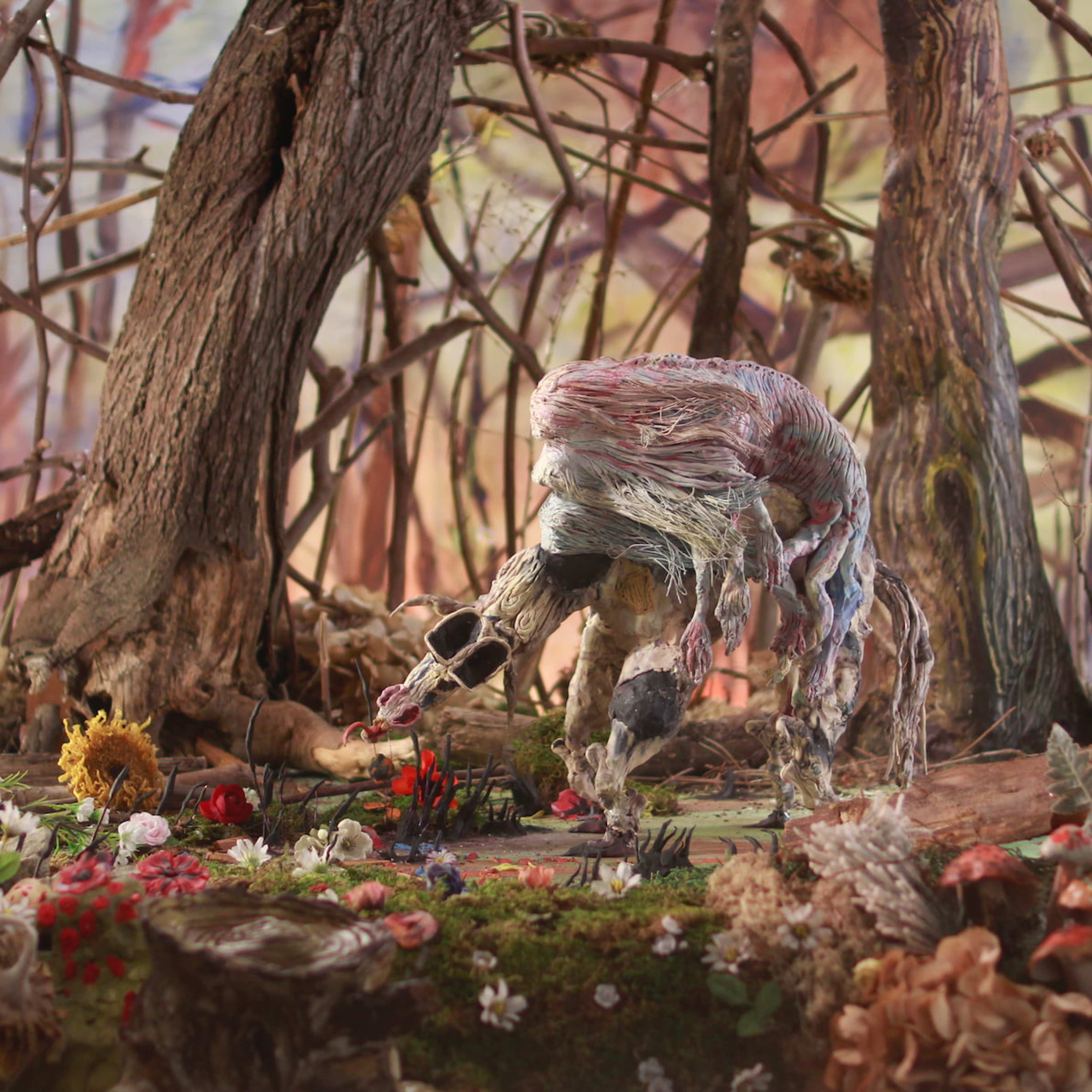 A forest scene with mythical unrecognisable creature sculpted in coloured clay or plasticine