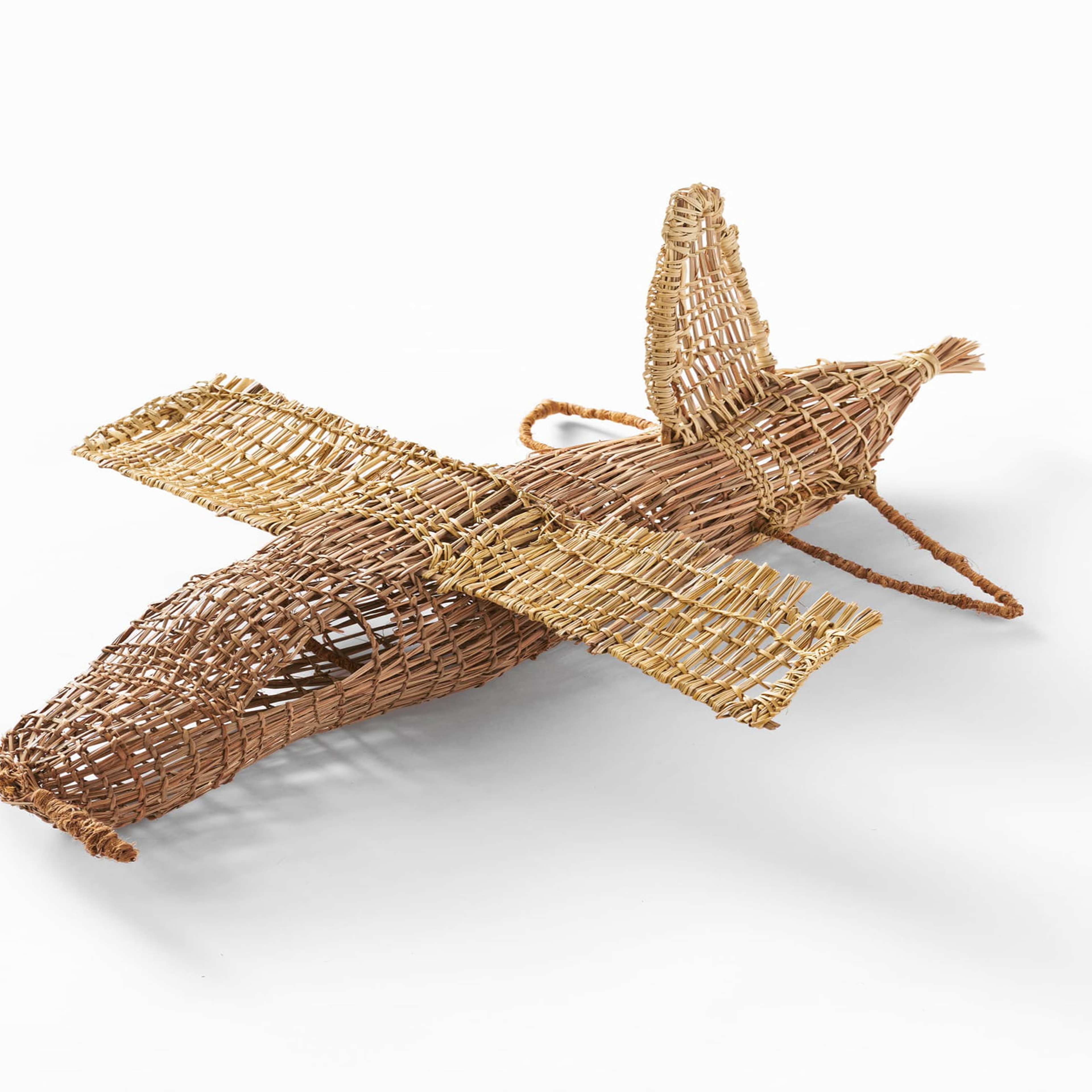 A small propeller plane made of a hessian material sits on a white background