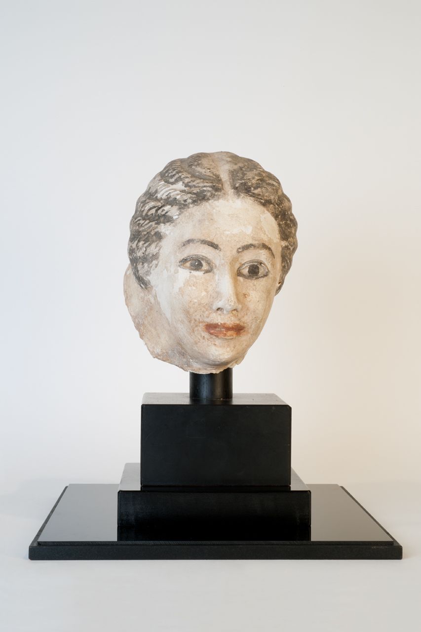 Sculpture of funerary mask of a woman made out of plaster, paint, and cartonnage dated 30 BCE to 600 CE