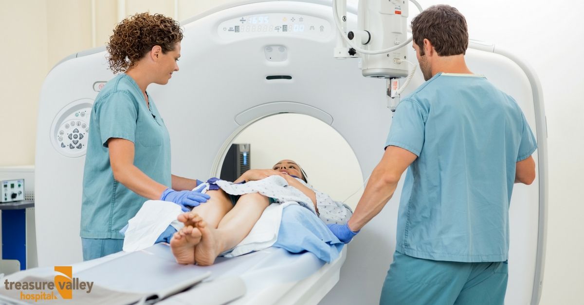 Two Technicians Standing Next to a Woman Getting a Scan | Treasure Valley Hospital