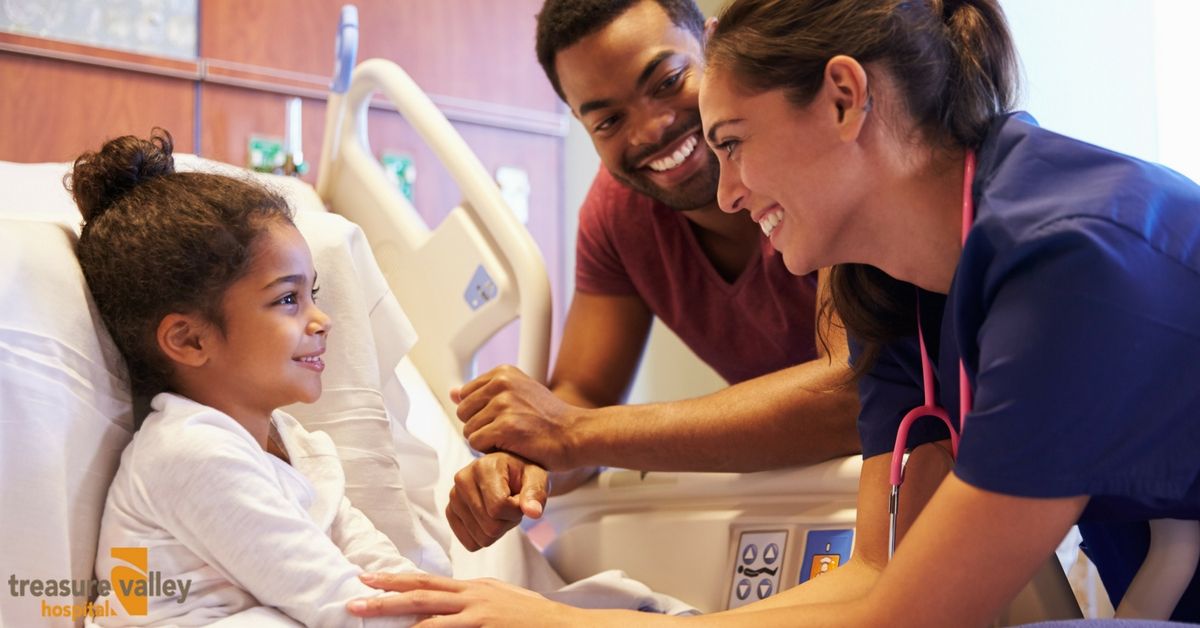 Smiling Nurse, Patient, and Parent at a Hospital Bed | Treasure Valley Hospital