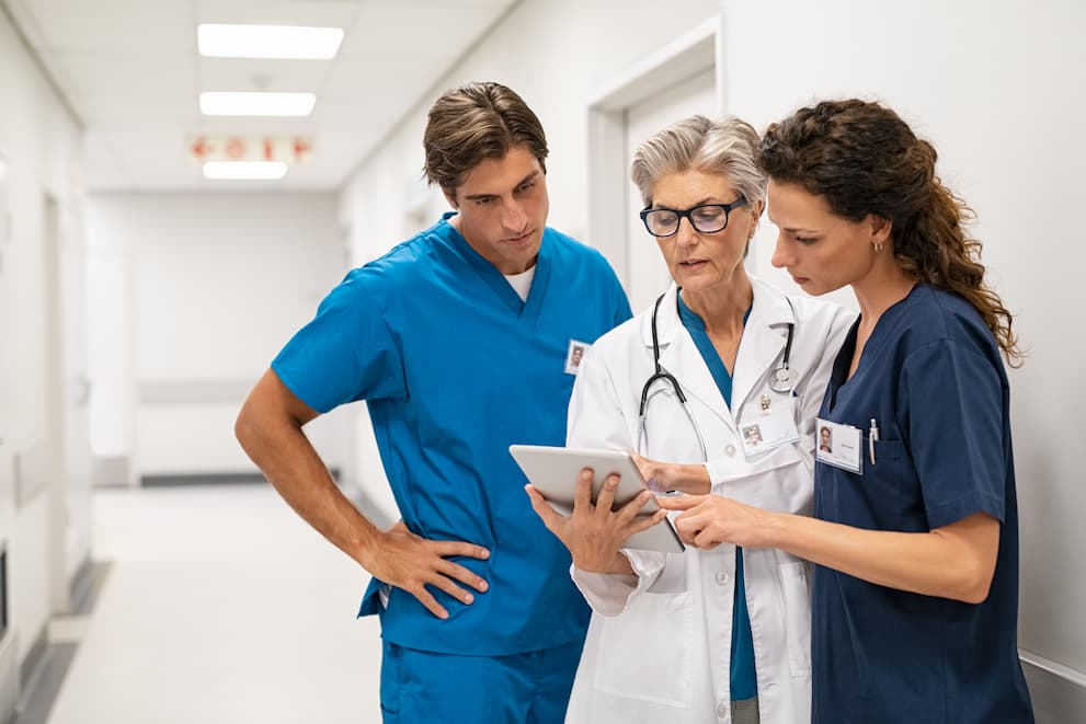 Doctors talking to each while looking at a tablet | Treasure Valley Hospital Careers