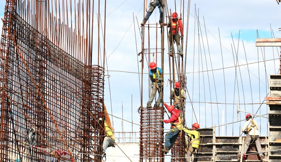 Construction workers wearing hard hats and safety equipment on construction site