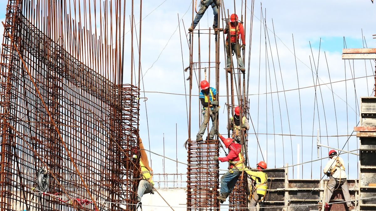 Construction workers wearing hard hats and safety equipment on construction site