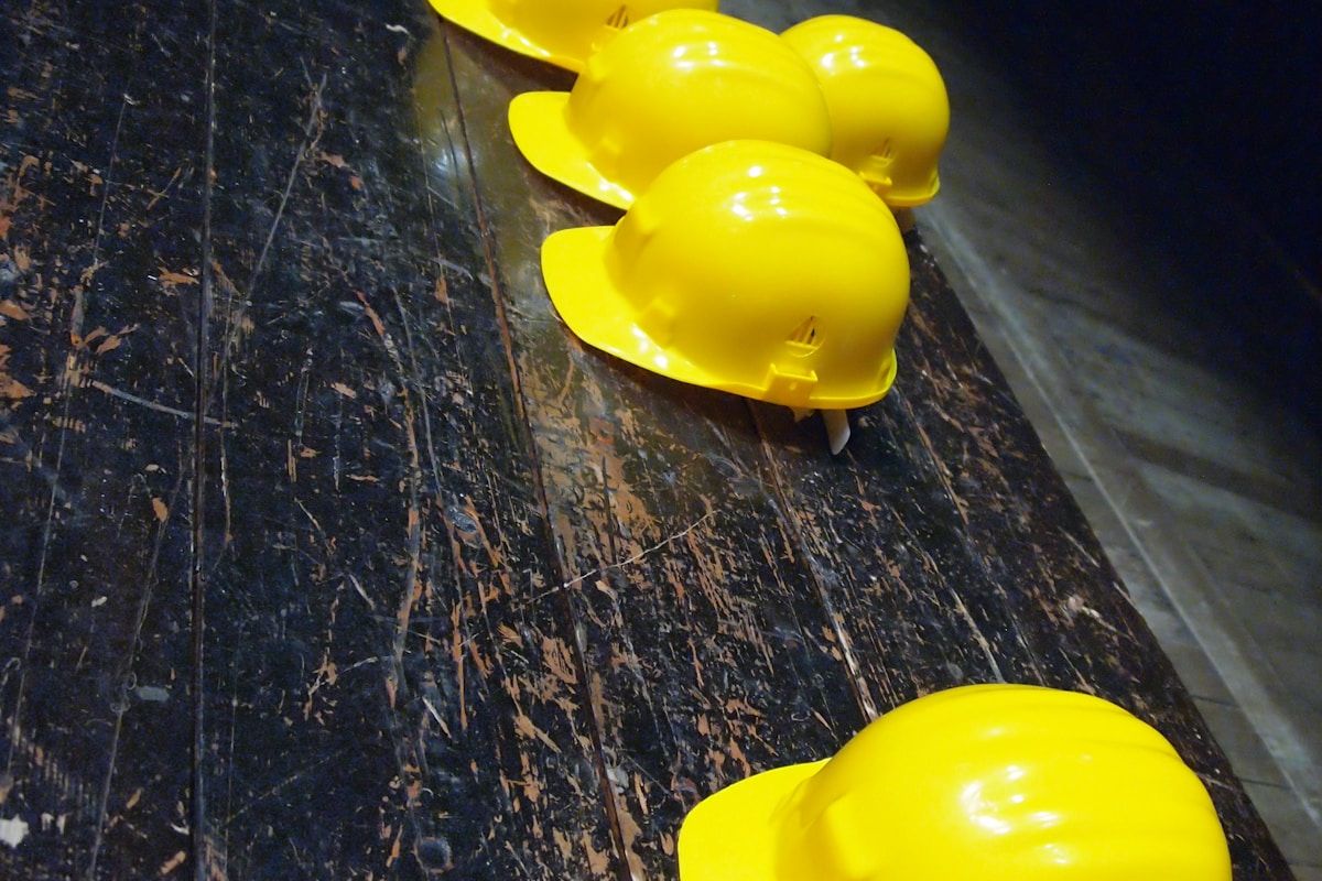 Collection of construction personal protective equipment including hard hats and safety gear