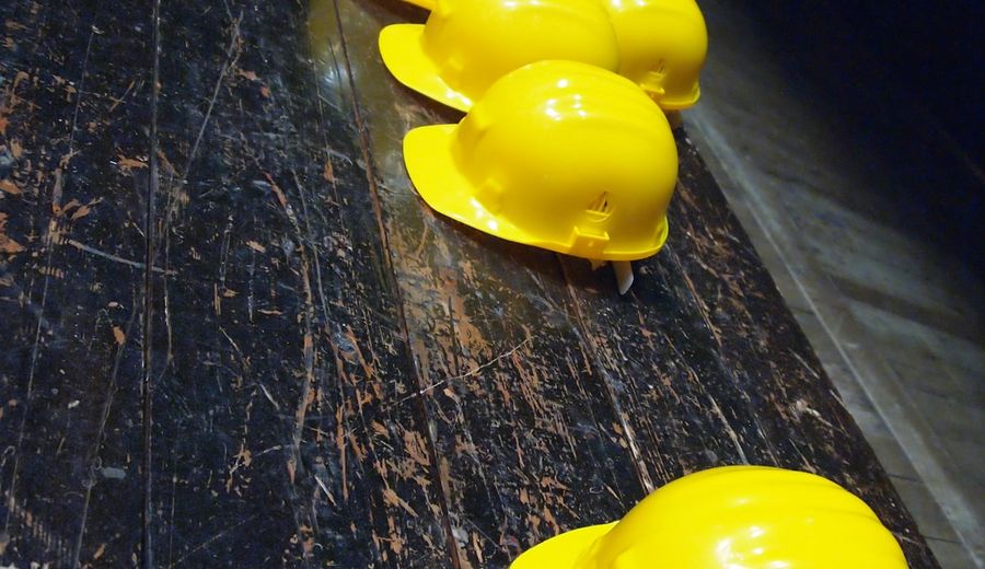 Collection of construction personal protective equipment including hard hats and safety gear