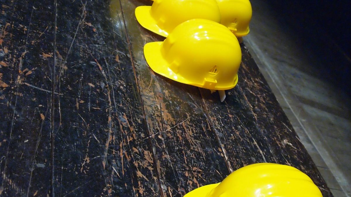 Collection of construction personal protective equipment including hard hats and safety gear