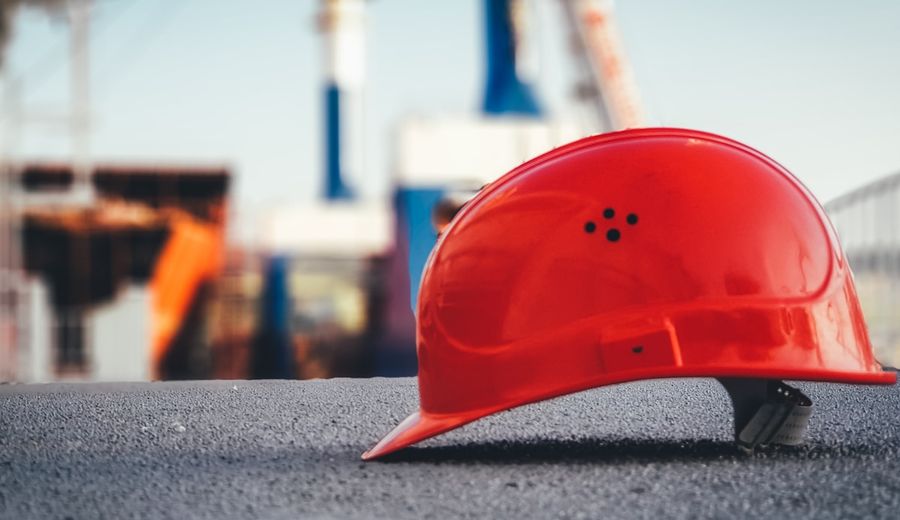 Red construction hard hat and safety equipment for fall protection