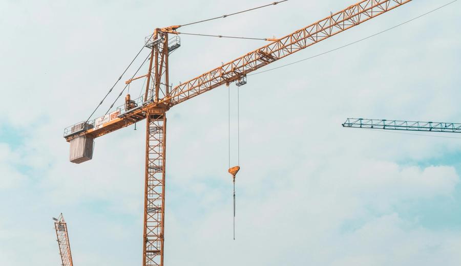 Construction crane and heavy equipment operations with safety protocols