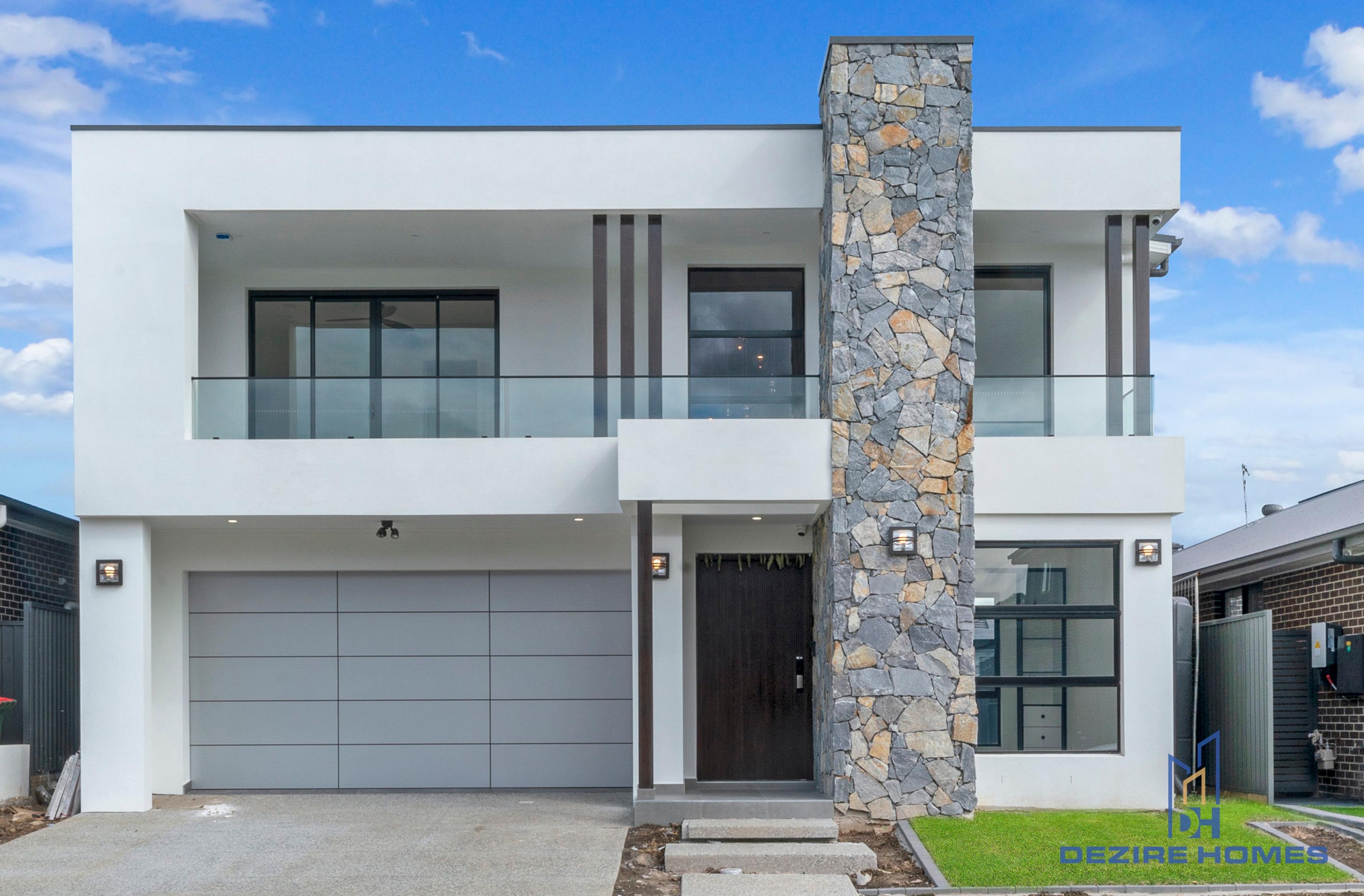 Double storey modern home with stacked stone facade and white exteriors