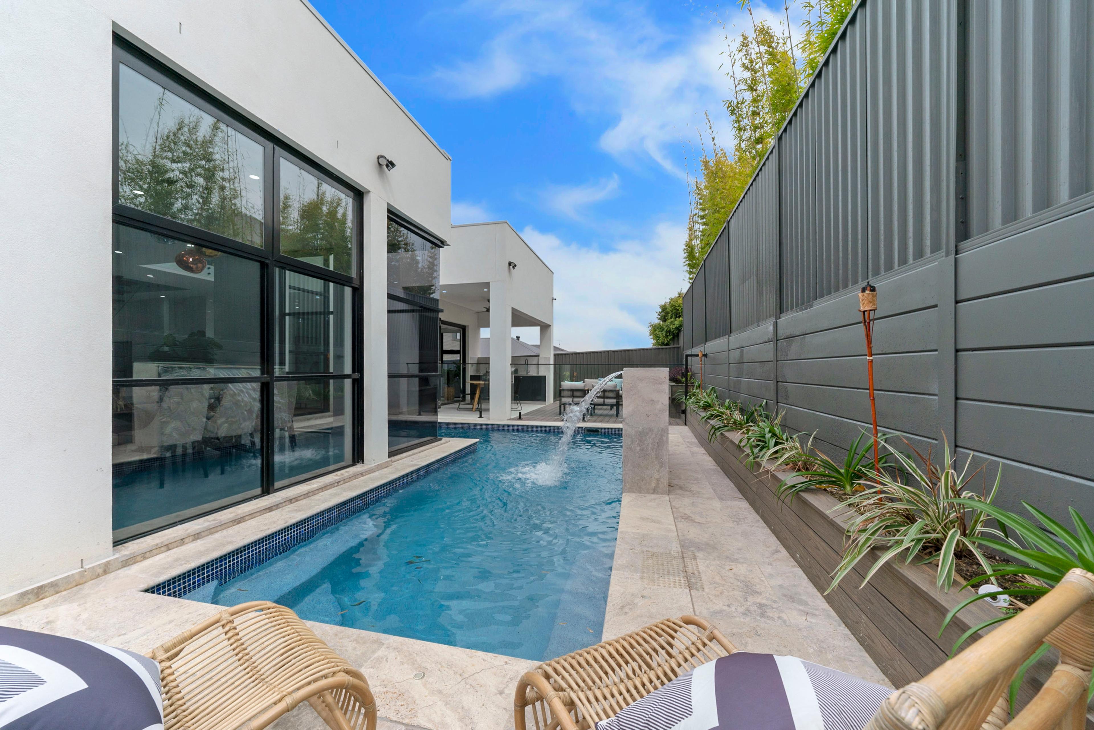 Dezire Homes build, backyard featuring a stylish pool