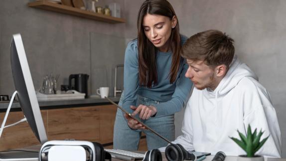 Woman showing something on a tablet to a men
