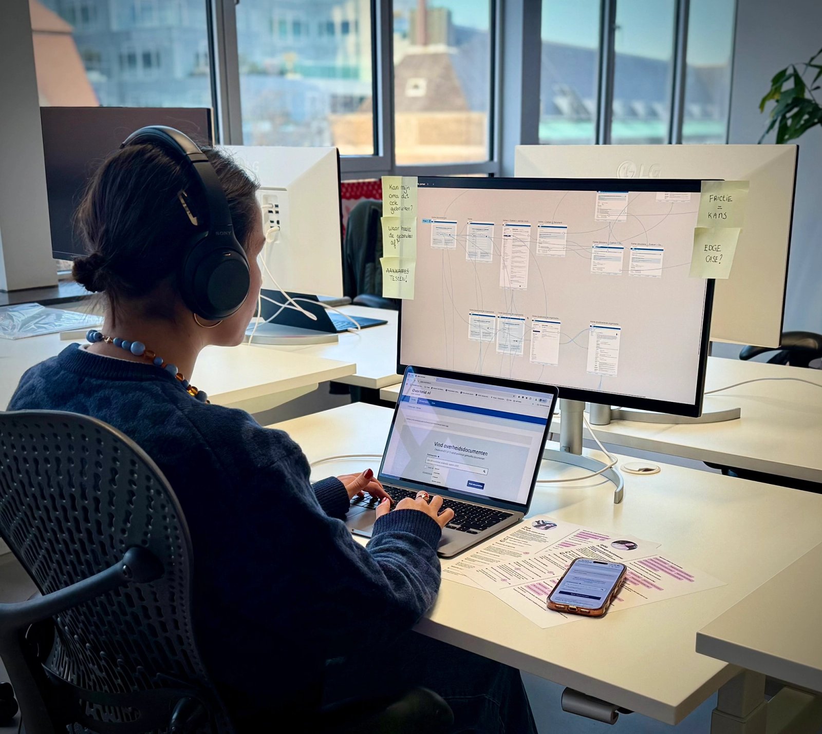Concentrated at her computer, UX researcher Noor works from the Humanoids office.