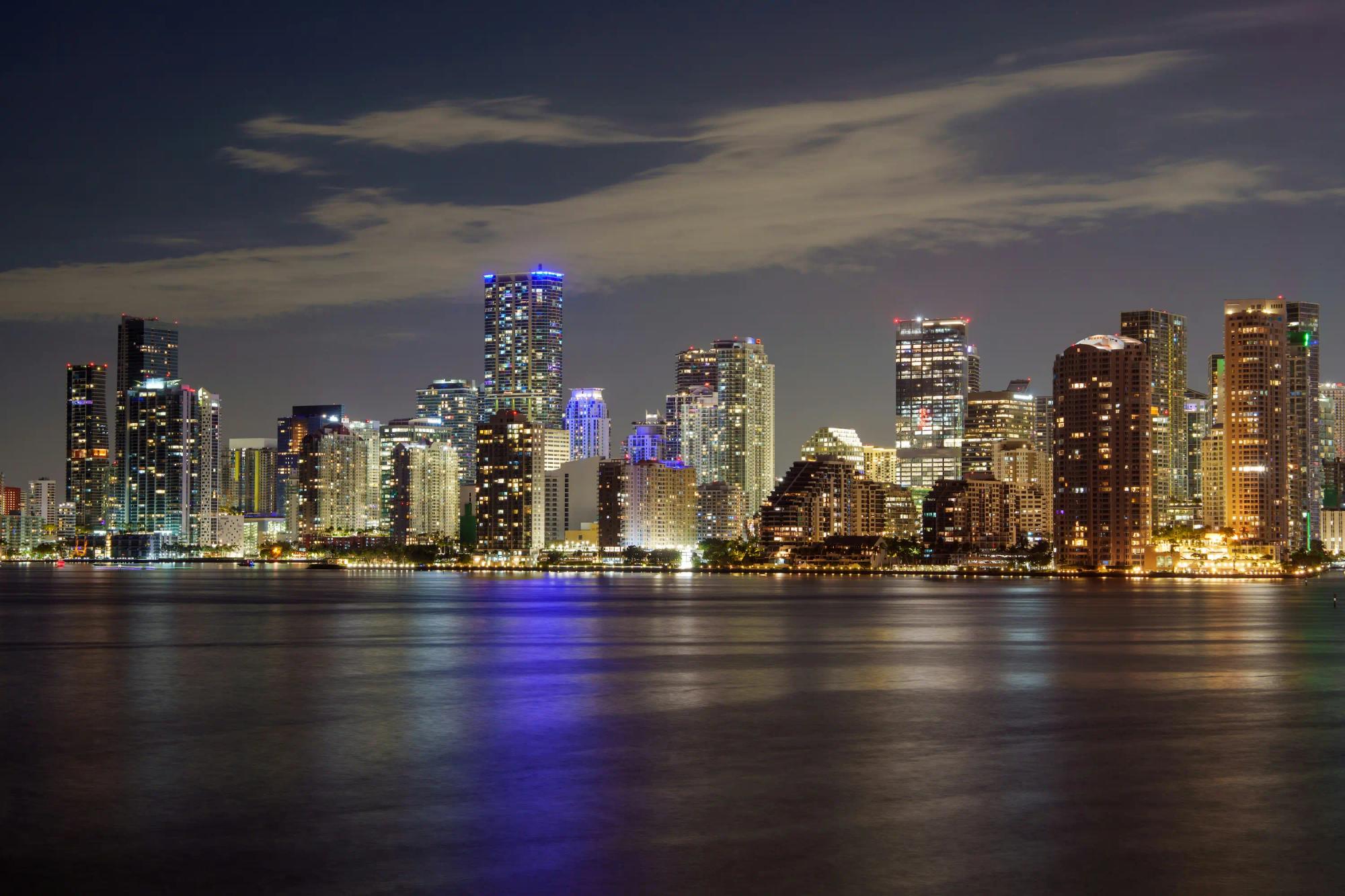 Miami skyline reflected in the water at night