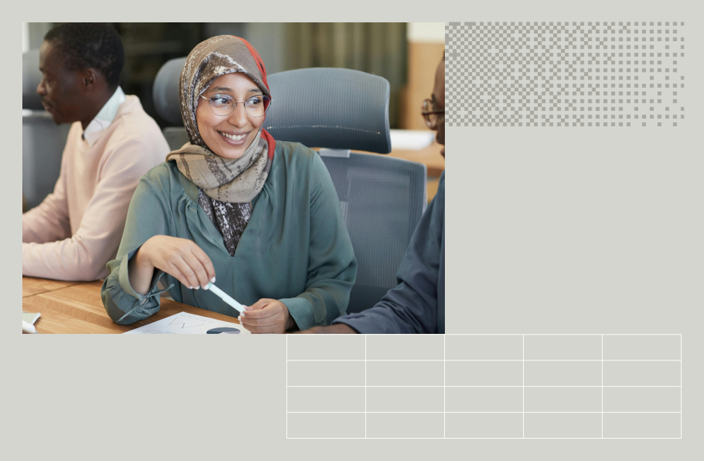 person at a conference room table with colleagues