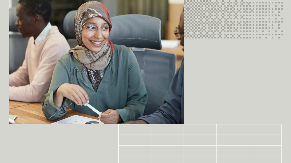 person at a conference room table with colleagues