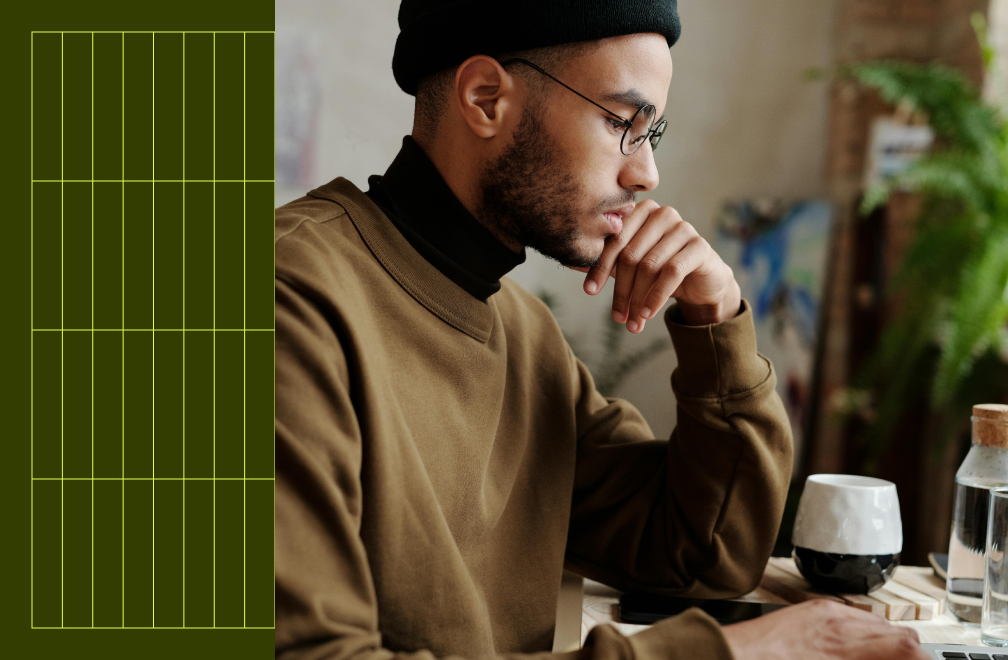man in glasses sitting at desk