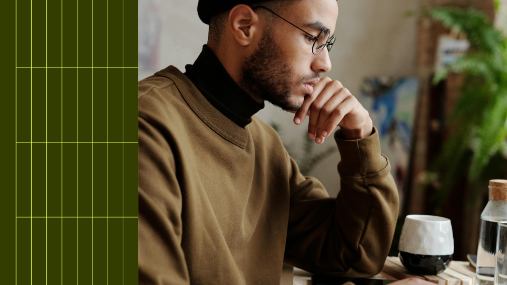 man in glasses sitting at desk