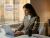 Woman working at desk with exploring Optro platform