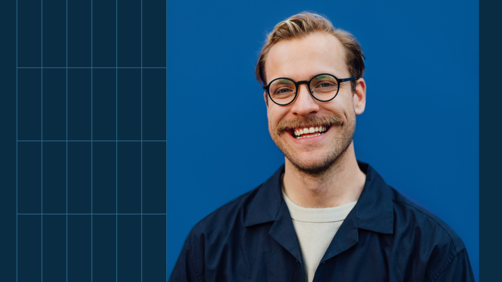 person with glasses smiling