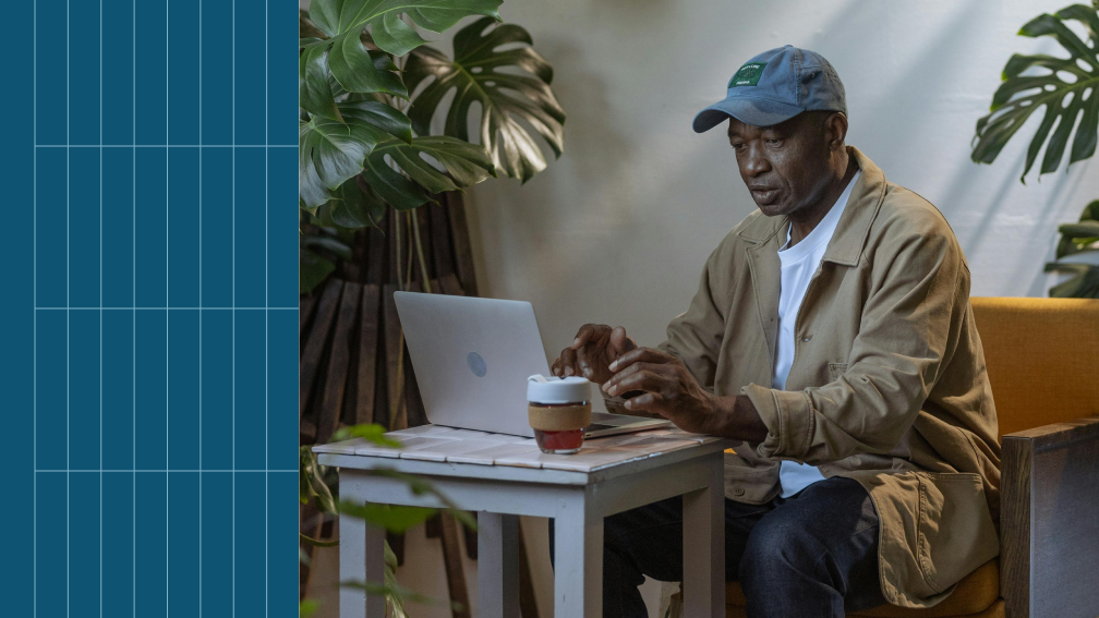 man working in cafe at laptop