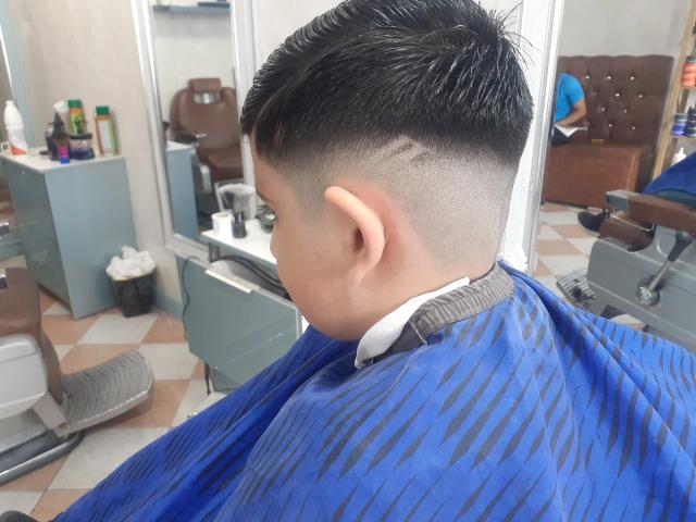 Skin fade finished with a blue cape