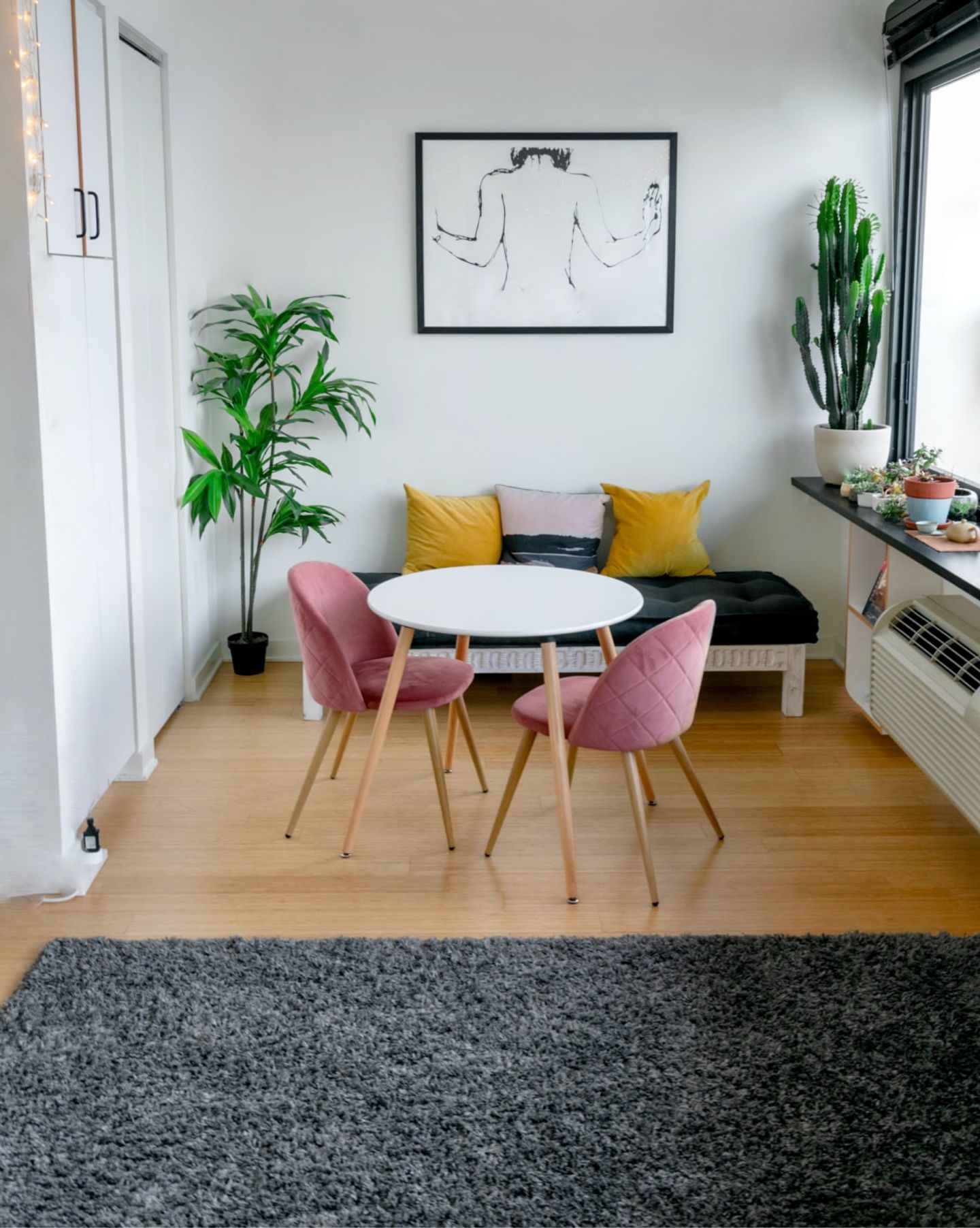 Small dining area with a clean wood floor and grey rug