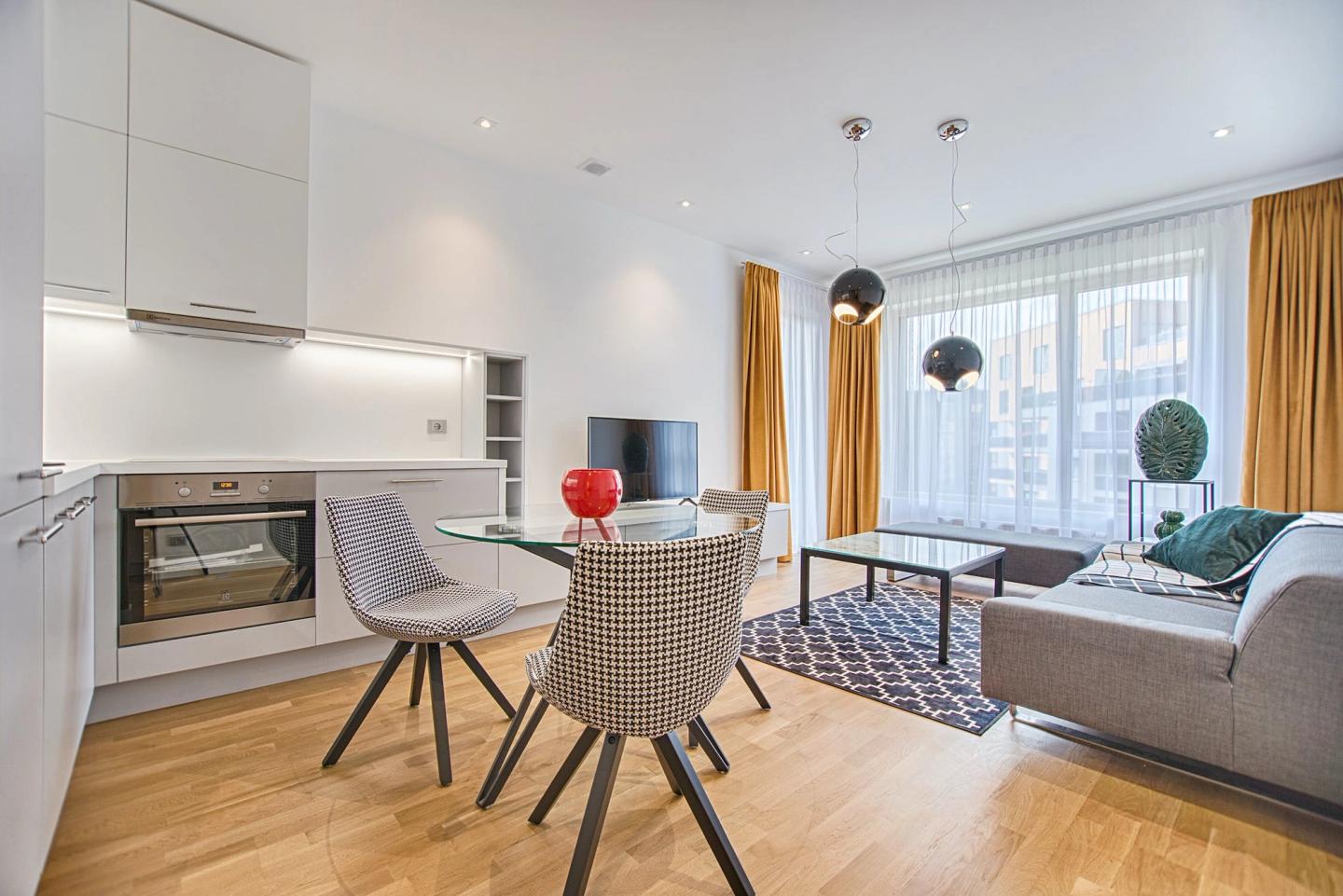 Clean modern open-plan kitchen and living room with a dining table