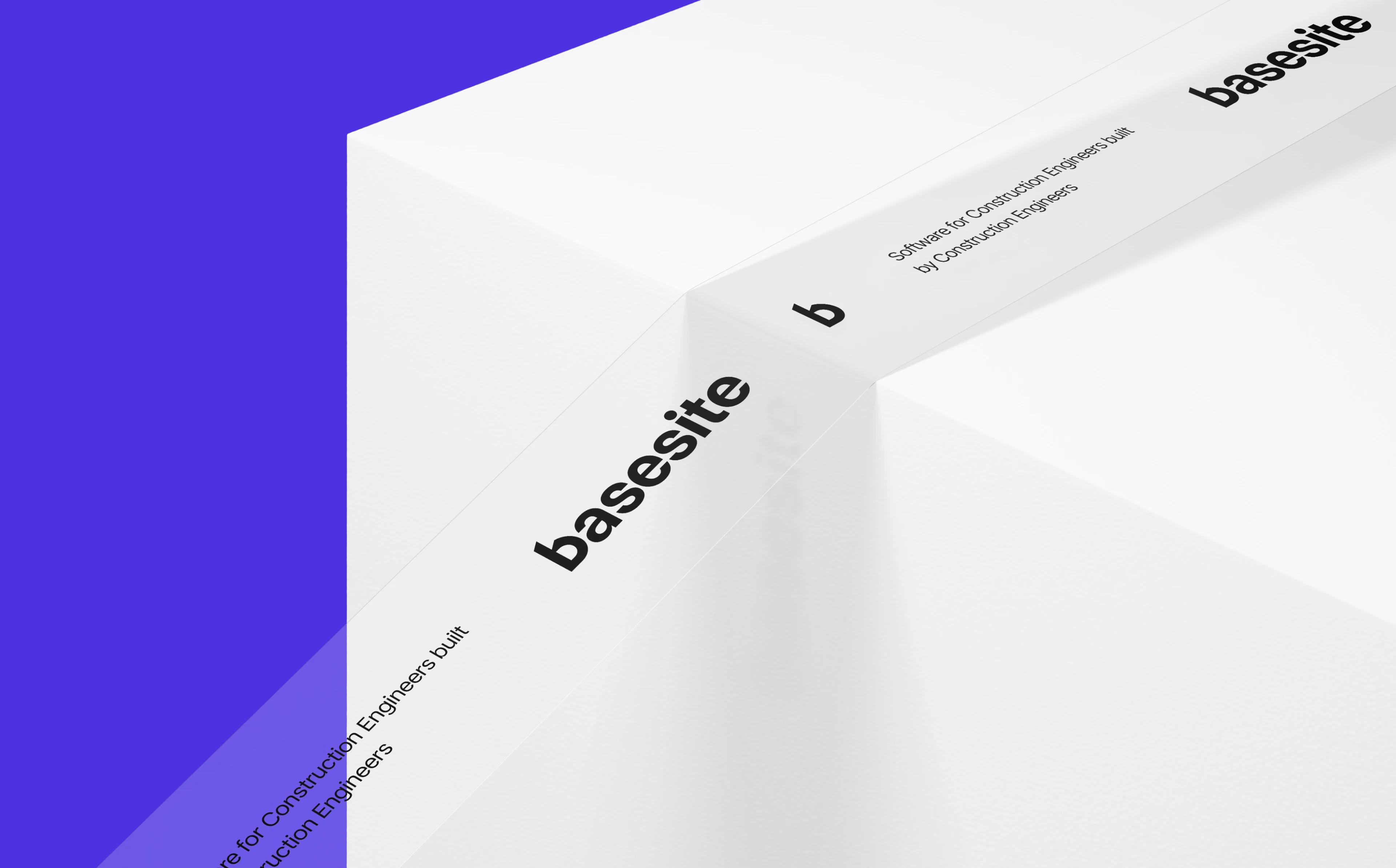 White Basesite packaging box close-up with wordmark and tagline on a violet background