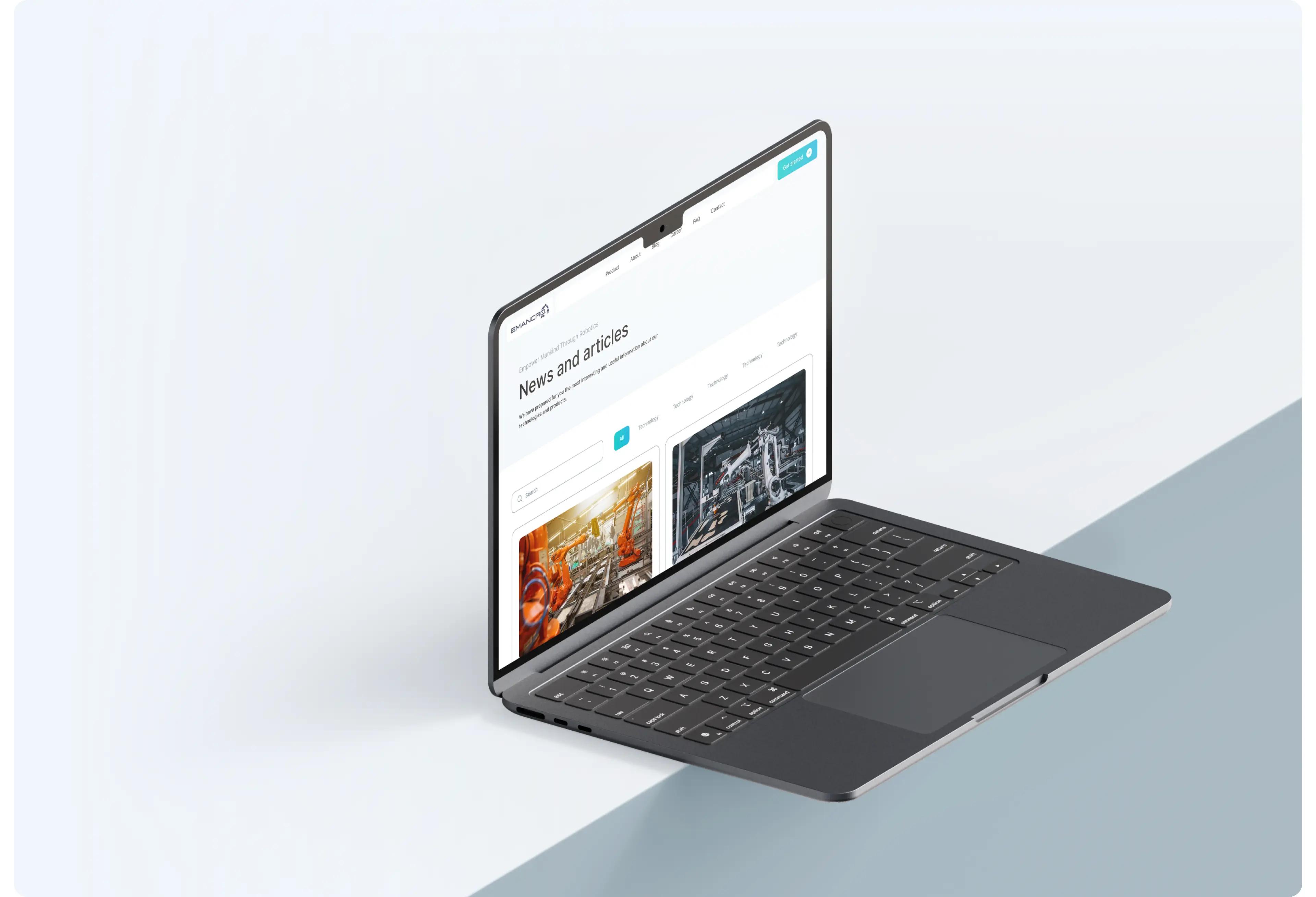 Emancro News and articles page shown on a laptop