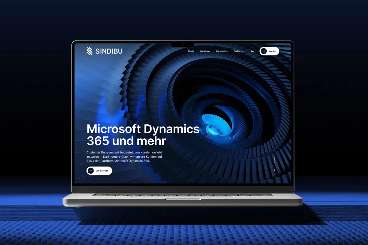 Sindibu website on a laptop: Microsoft Dynamics 365 hero with a blue spiral graphic