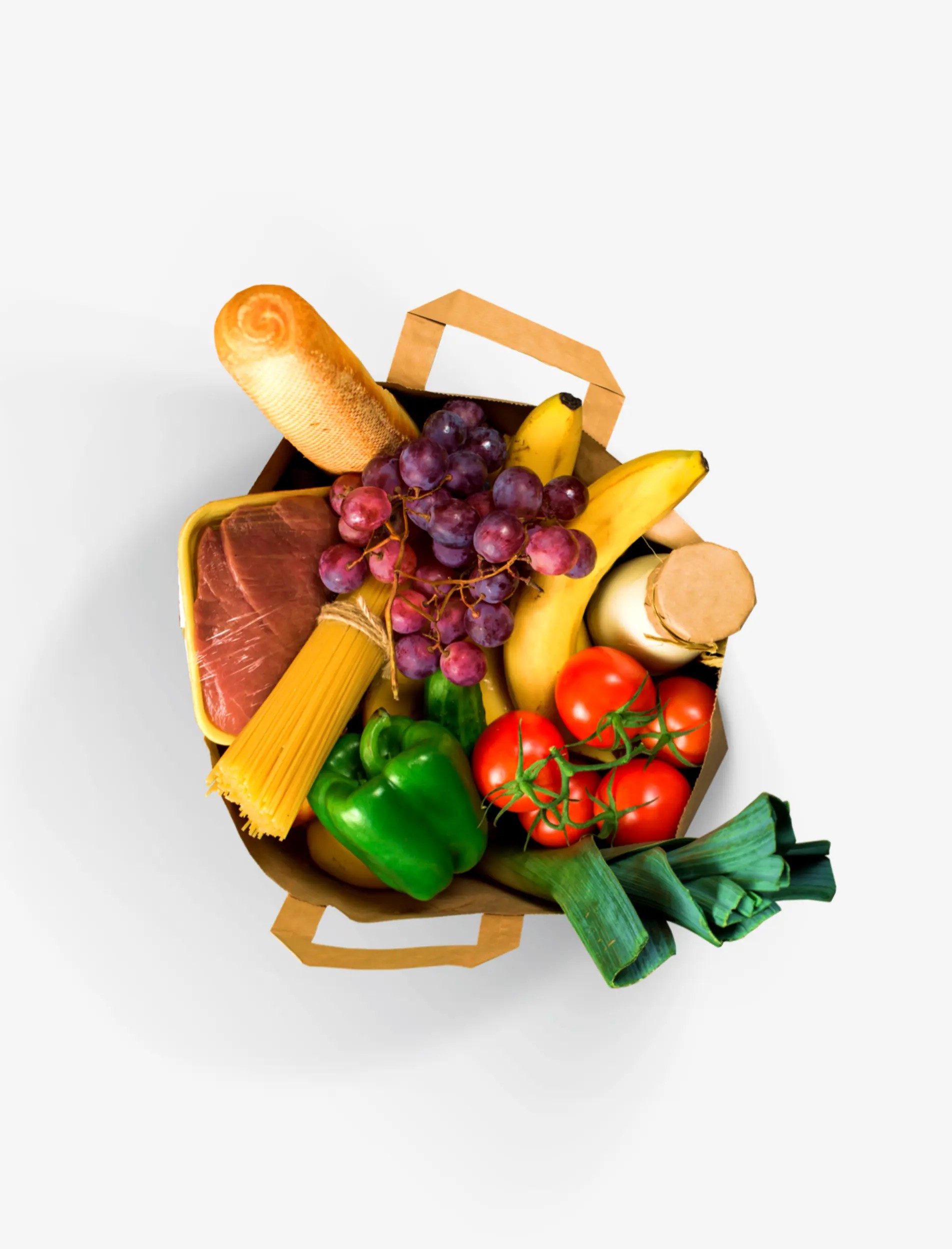 Top-down view of a paper grocery bag with bread, grapes, bananas, pasta, meat, tomatoes and peppers