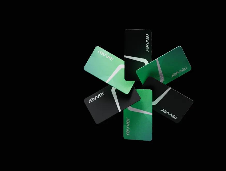 Revver payment cards in green and black fanned out on a dark background