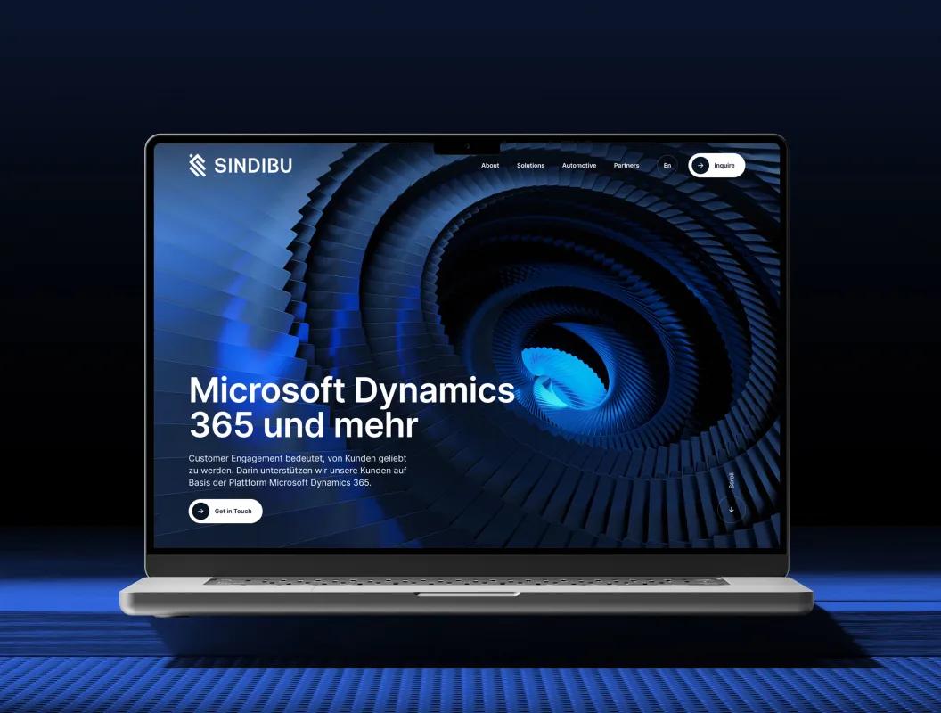 Laptop displaying creative design and development studio website with abstract blue digital spiral background.
