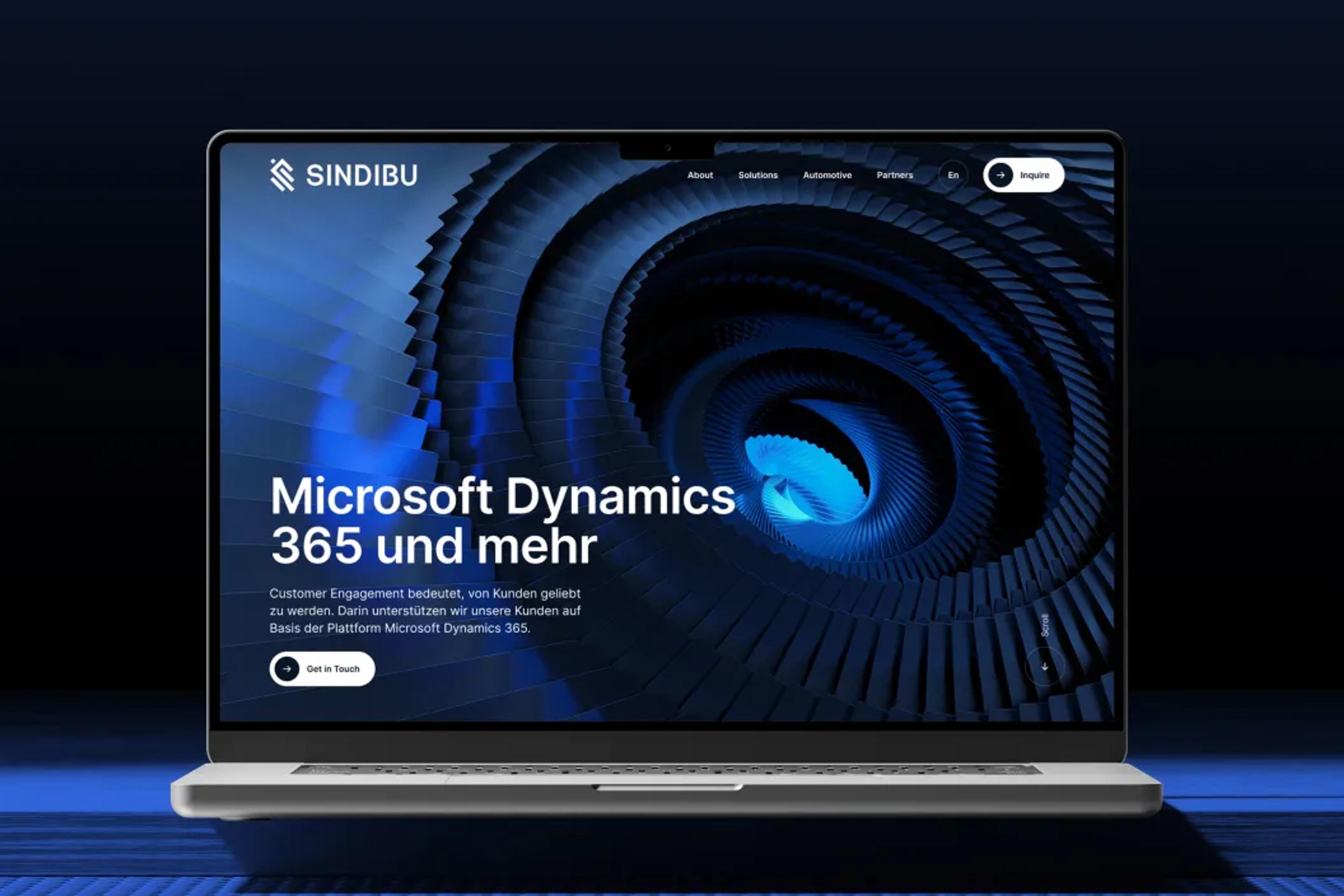 Laptop displaying creative design and development studio website with abstract blue digital spiral background.